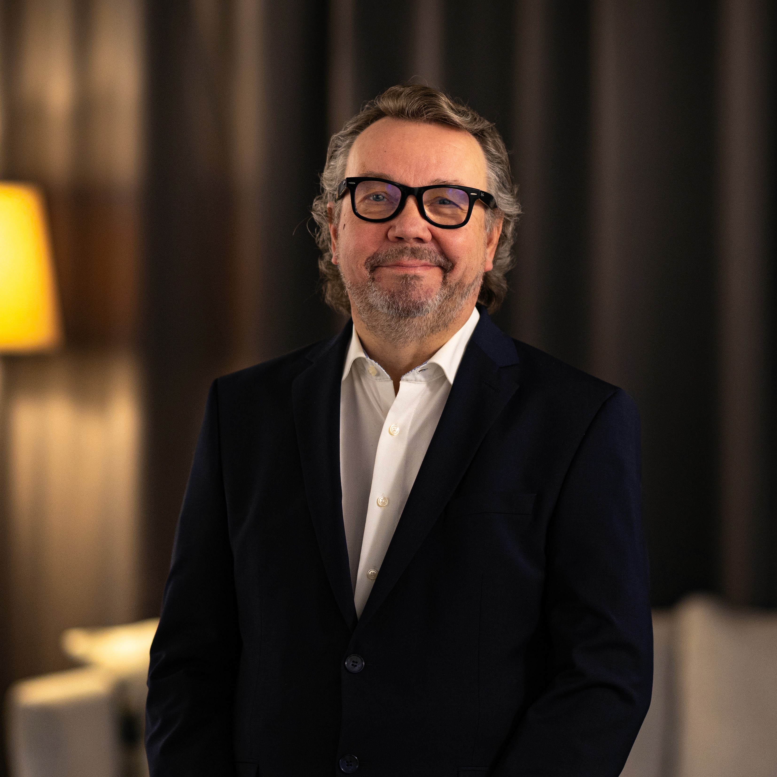 Portrait of John Doe Anderson, CEO of Omnis.