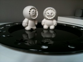 Two Anooki figurines standing on a black tray