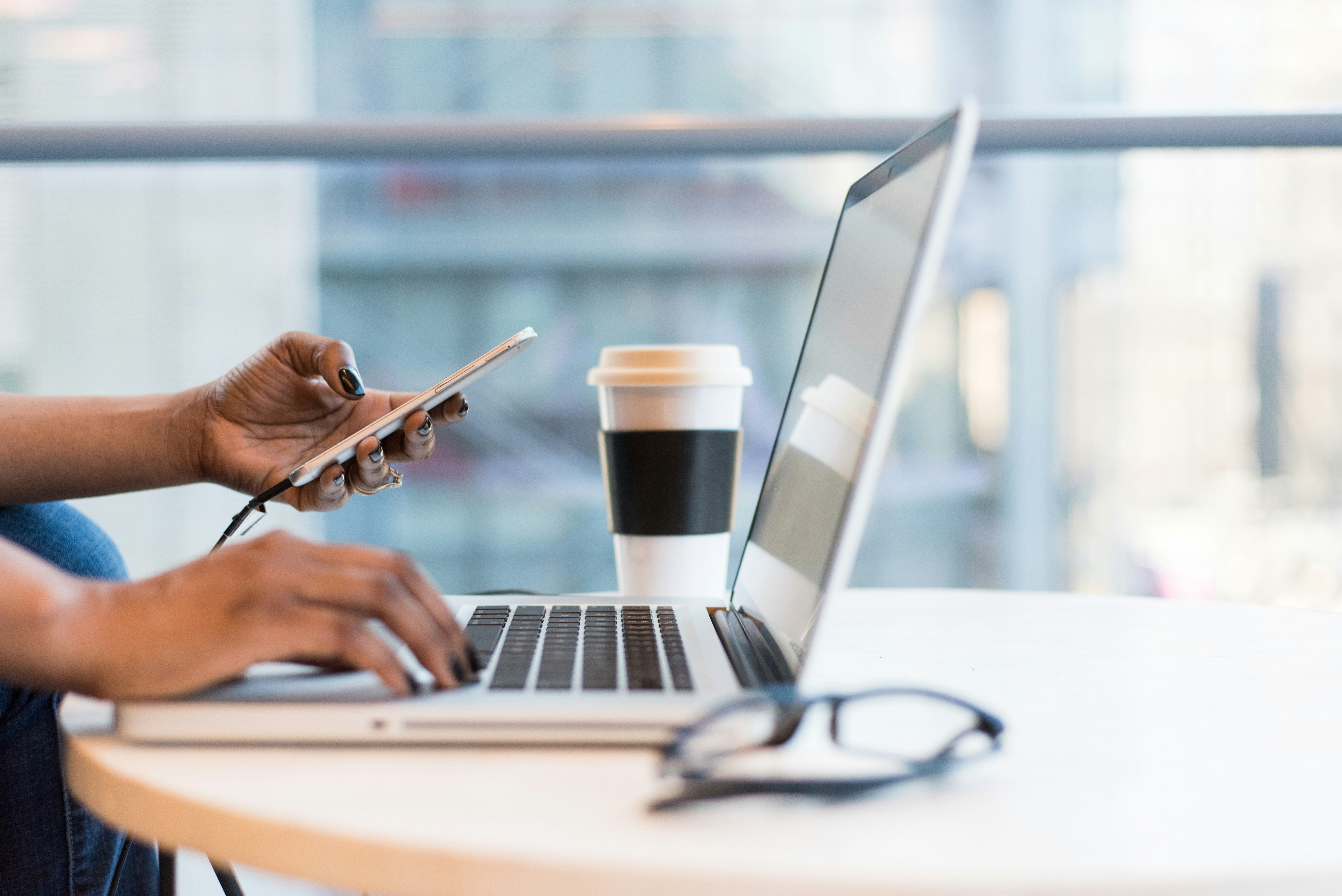 Person using Phone and Laptop- Hyperwrite Alternative