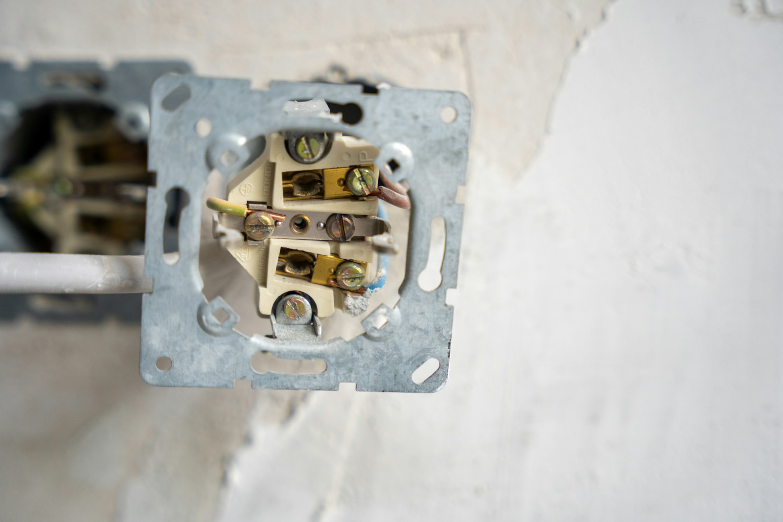 Electrical outlet opened to reveal wiring
