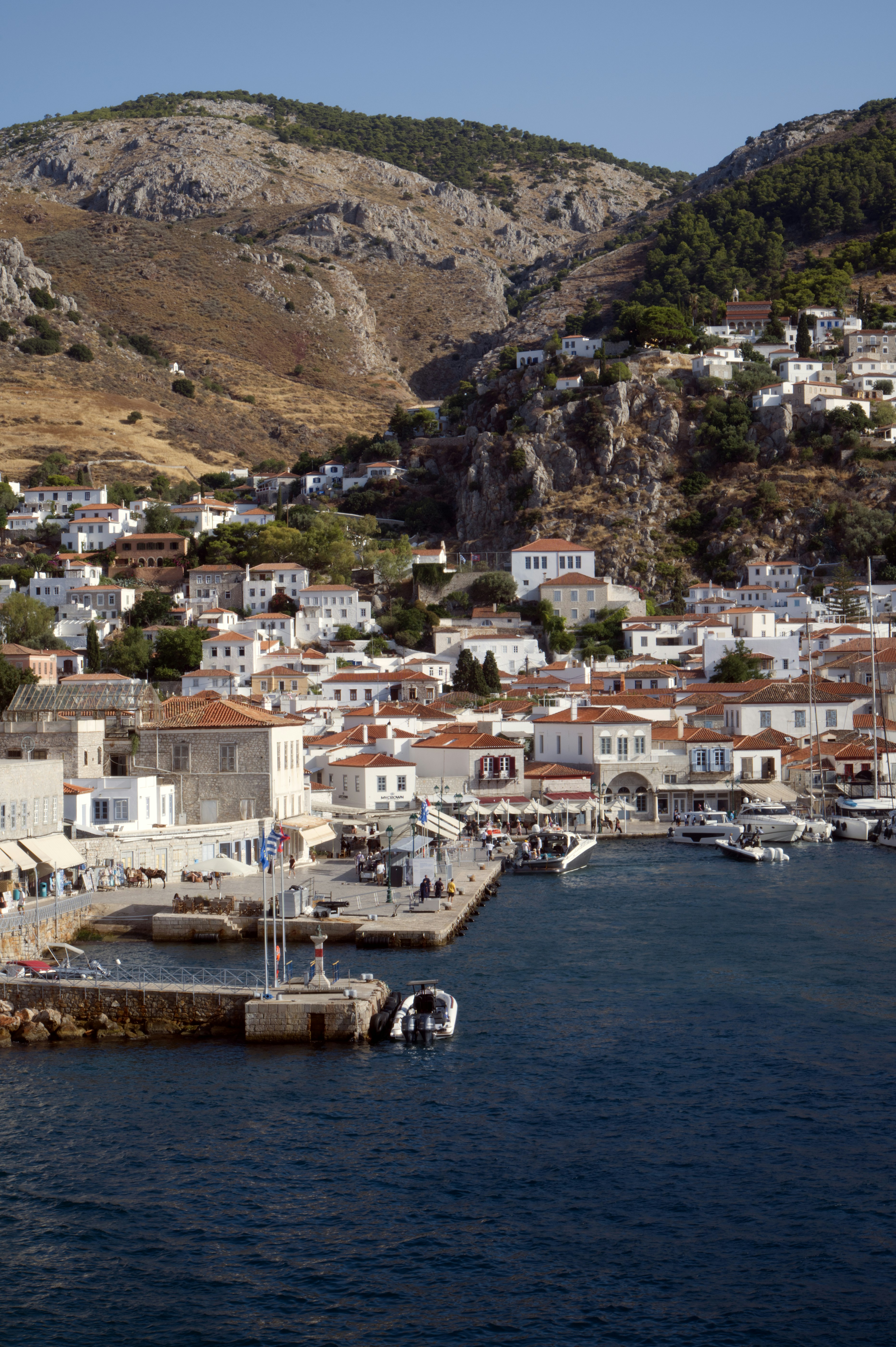 Hydra harbour and its stone houses rising above the waterfront
