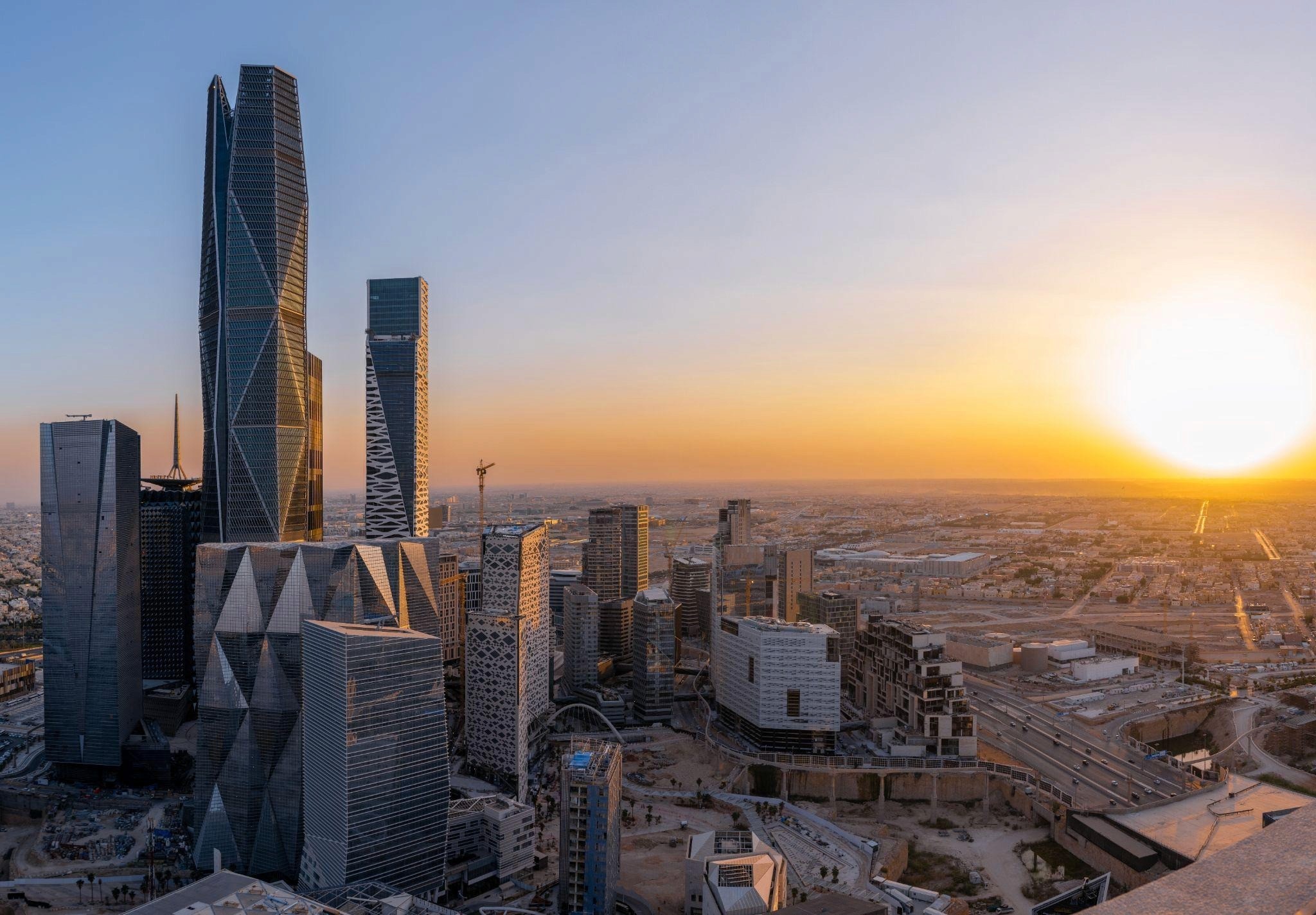 The PIF Tower in KAFD, a towering skyscraper with a sleek, futuristic design, rising prominently against the Riyadh skyline, reflecting the district’s modern architectural vision.