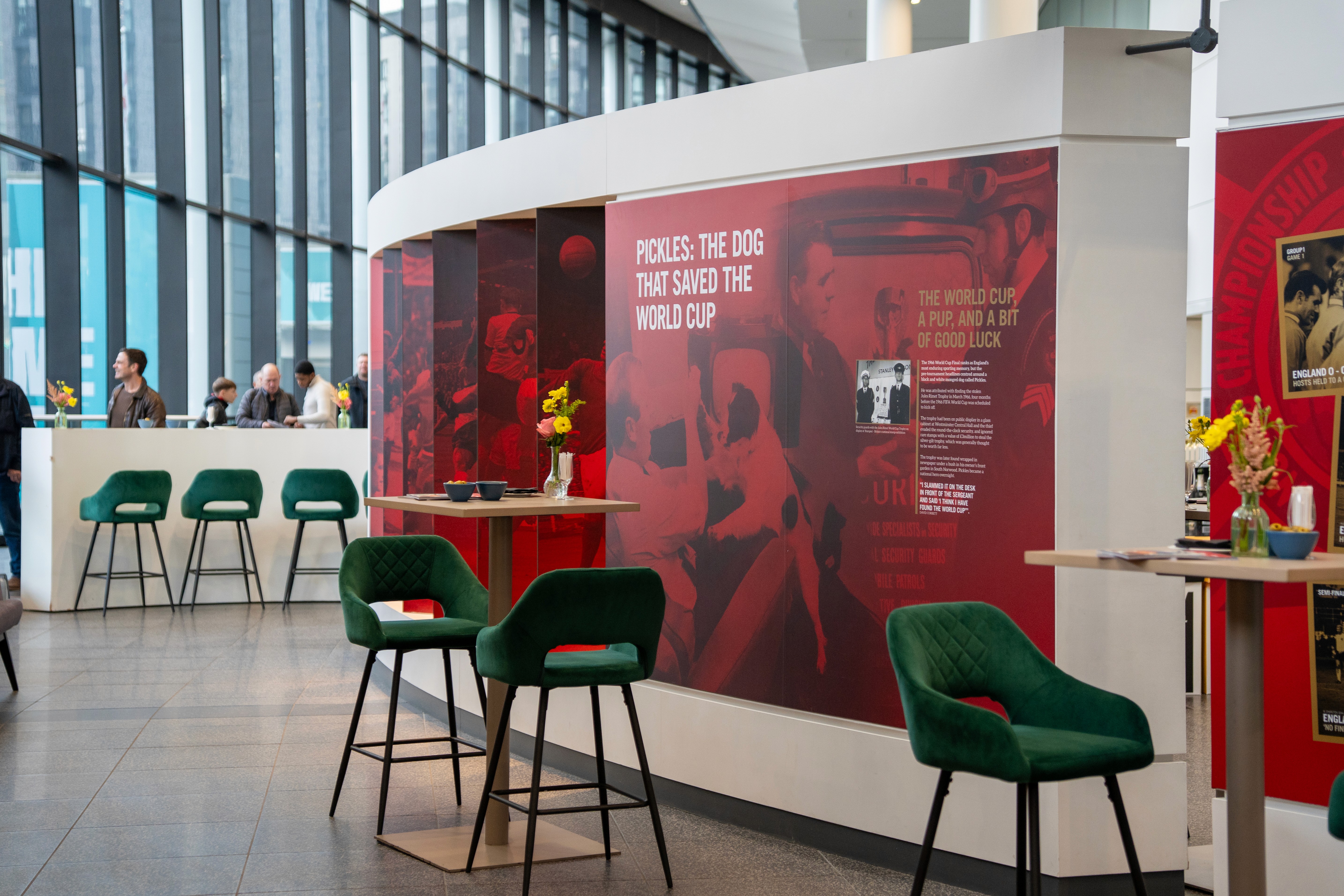 VIP lounge area at Wembley Stadium featuring modern seating, high tables, and wall displays, captured by Seven Media during the elevated experience event.