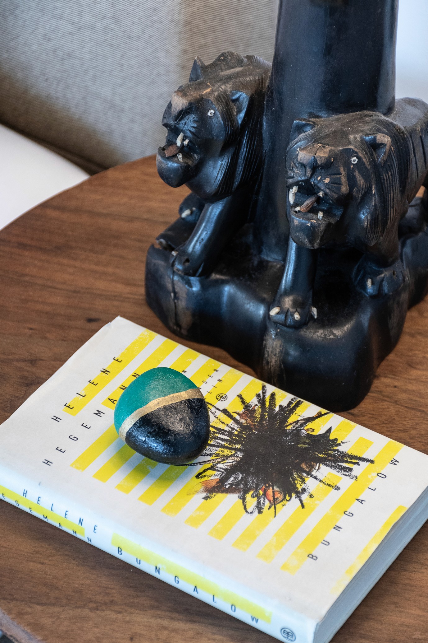A book and a sculpture resting on a coffee table