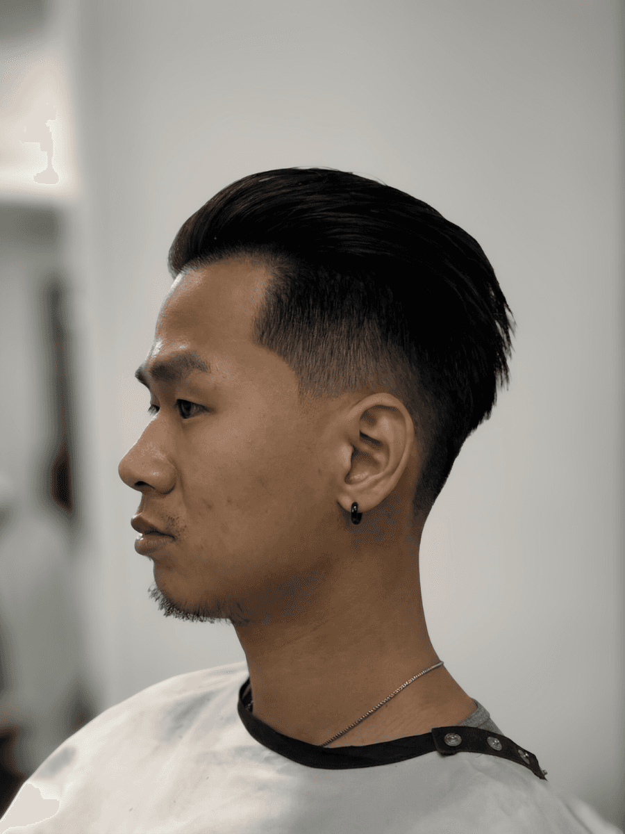 person holding white and gold hair comb