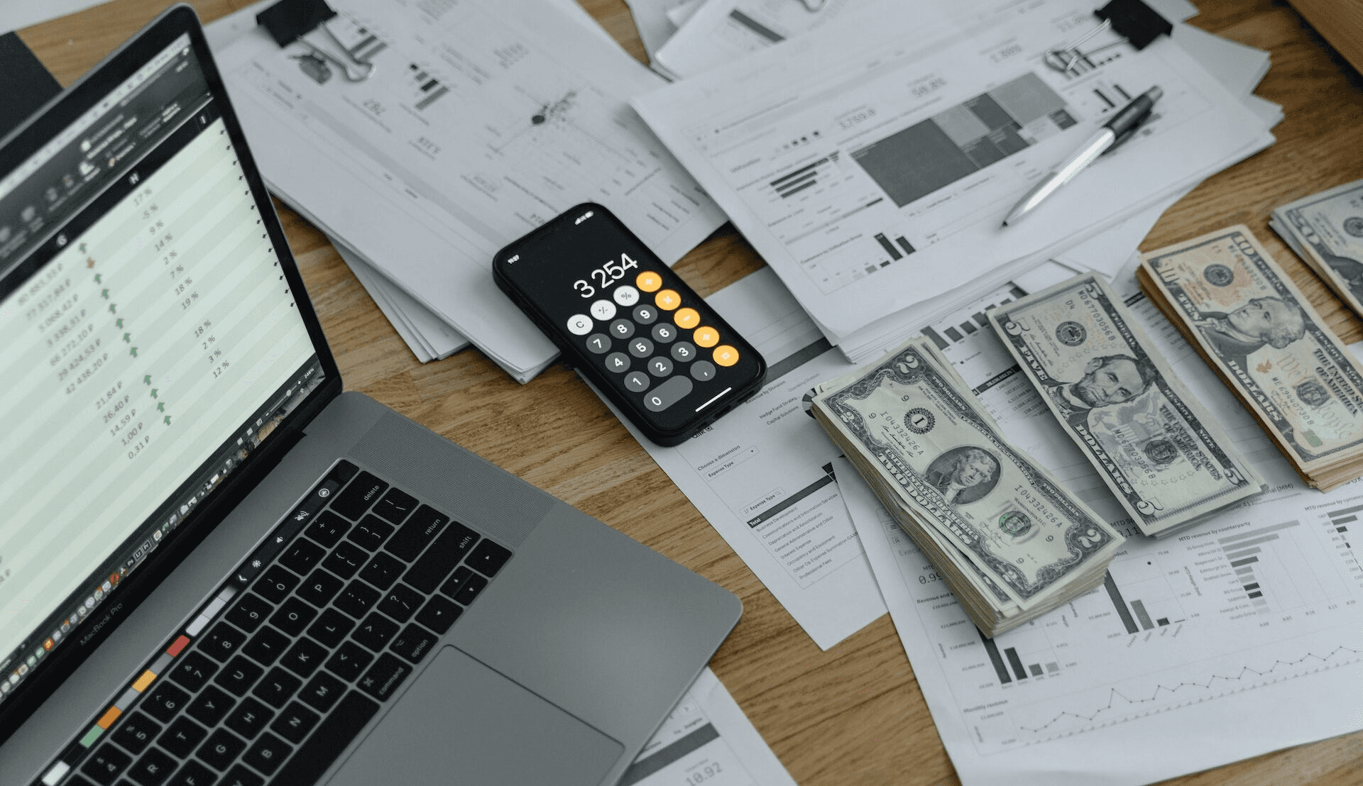 Image shows cash and financial documents - How to Categorize Small Business Expenses