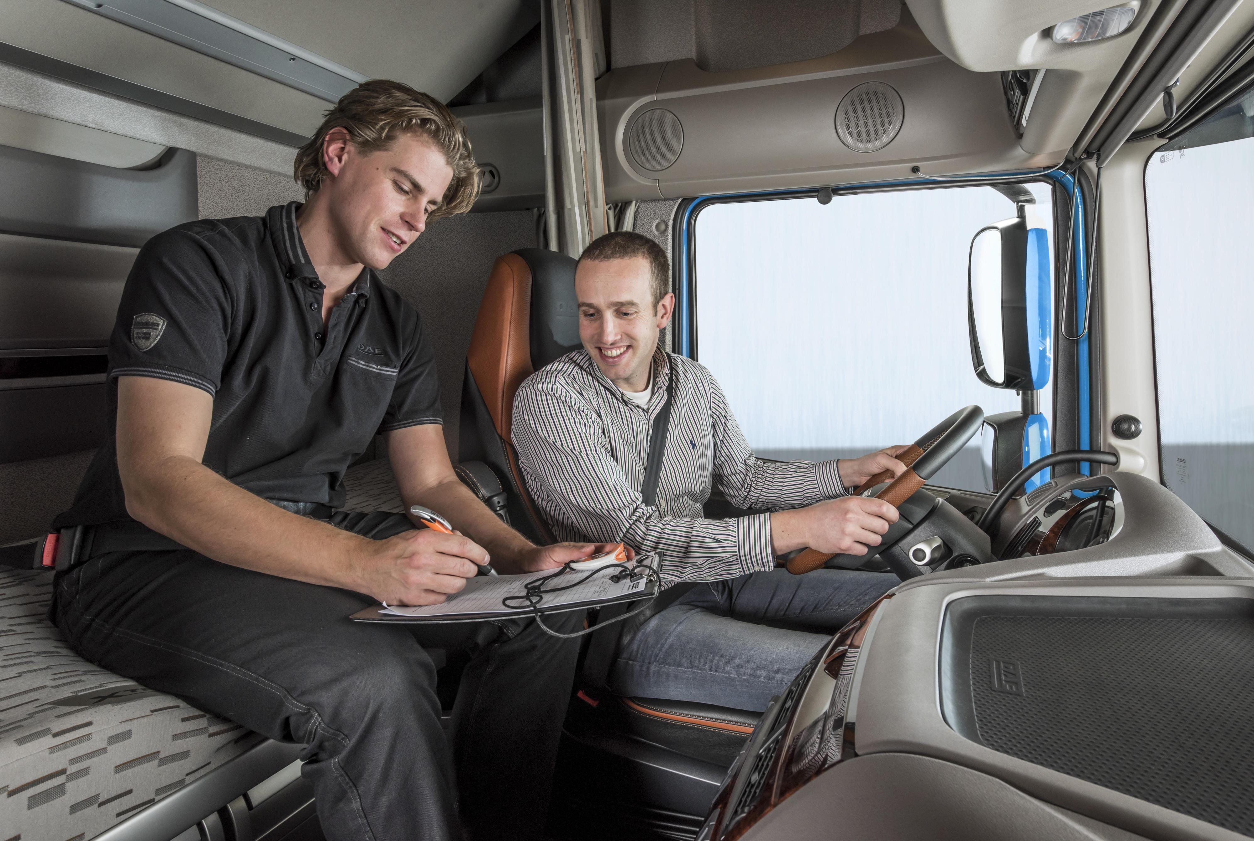 HGV drivers in a training session with an instructor, representing the new training programs funded by the logistics consortium.