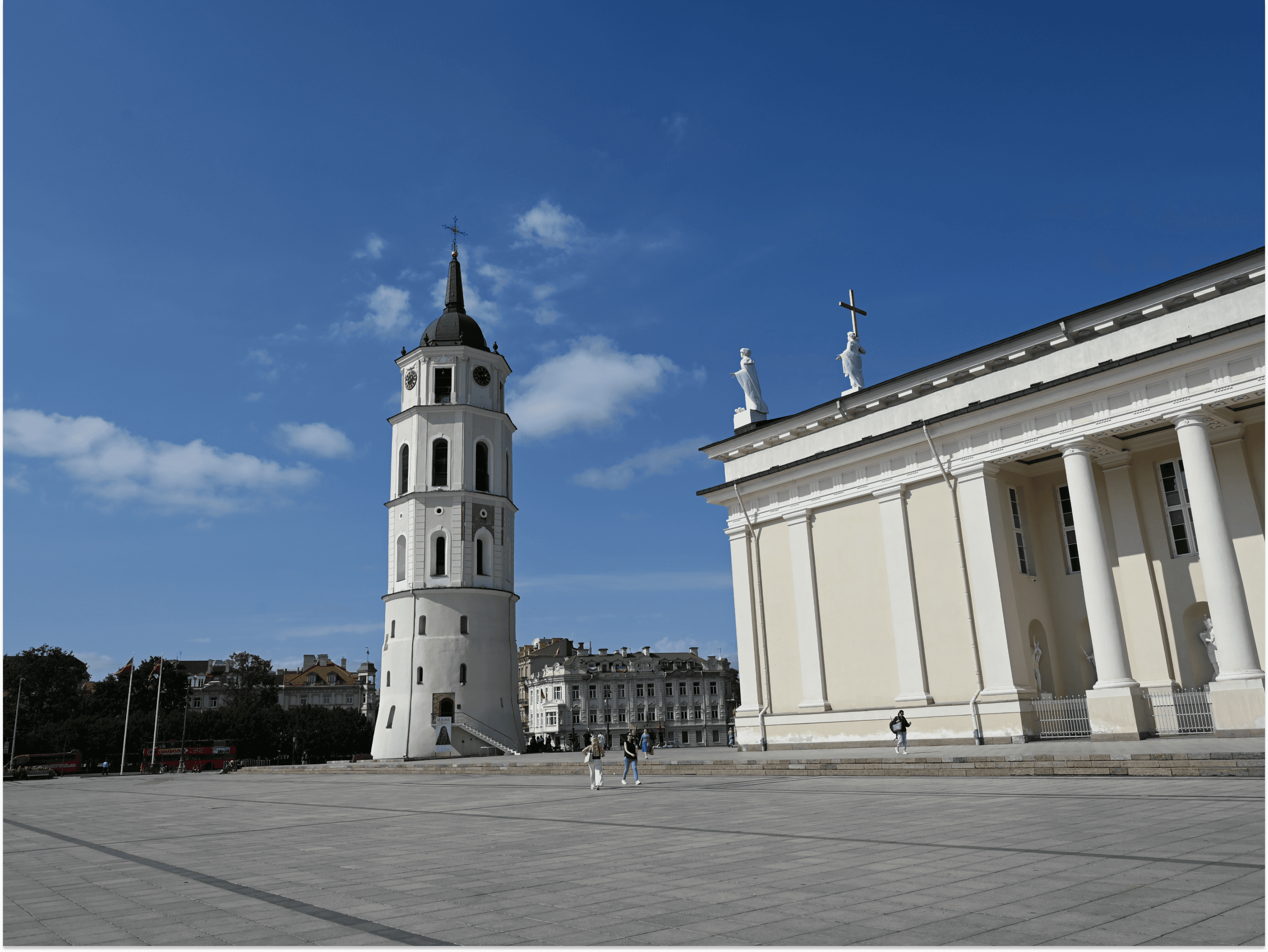 A white tower next to a square building