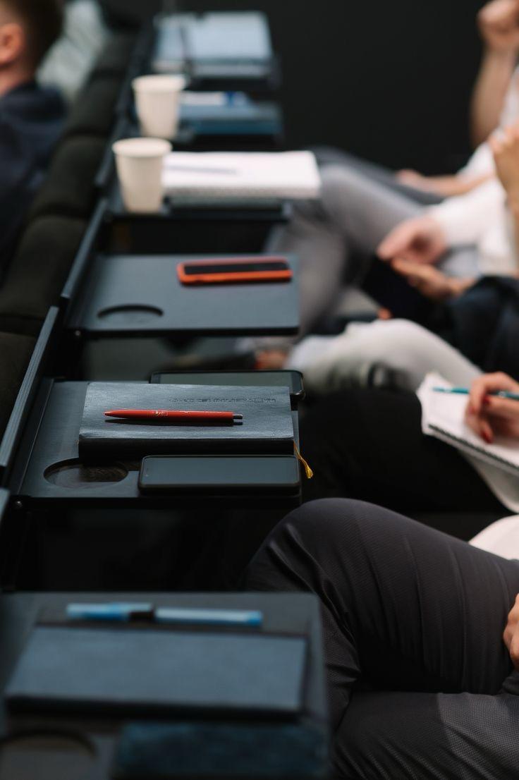 woman sitting around table holding tablet