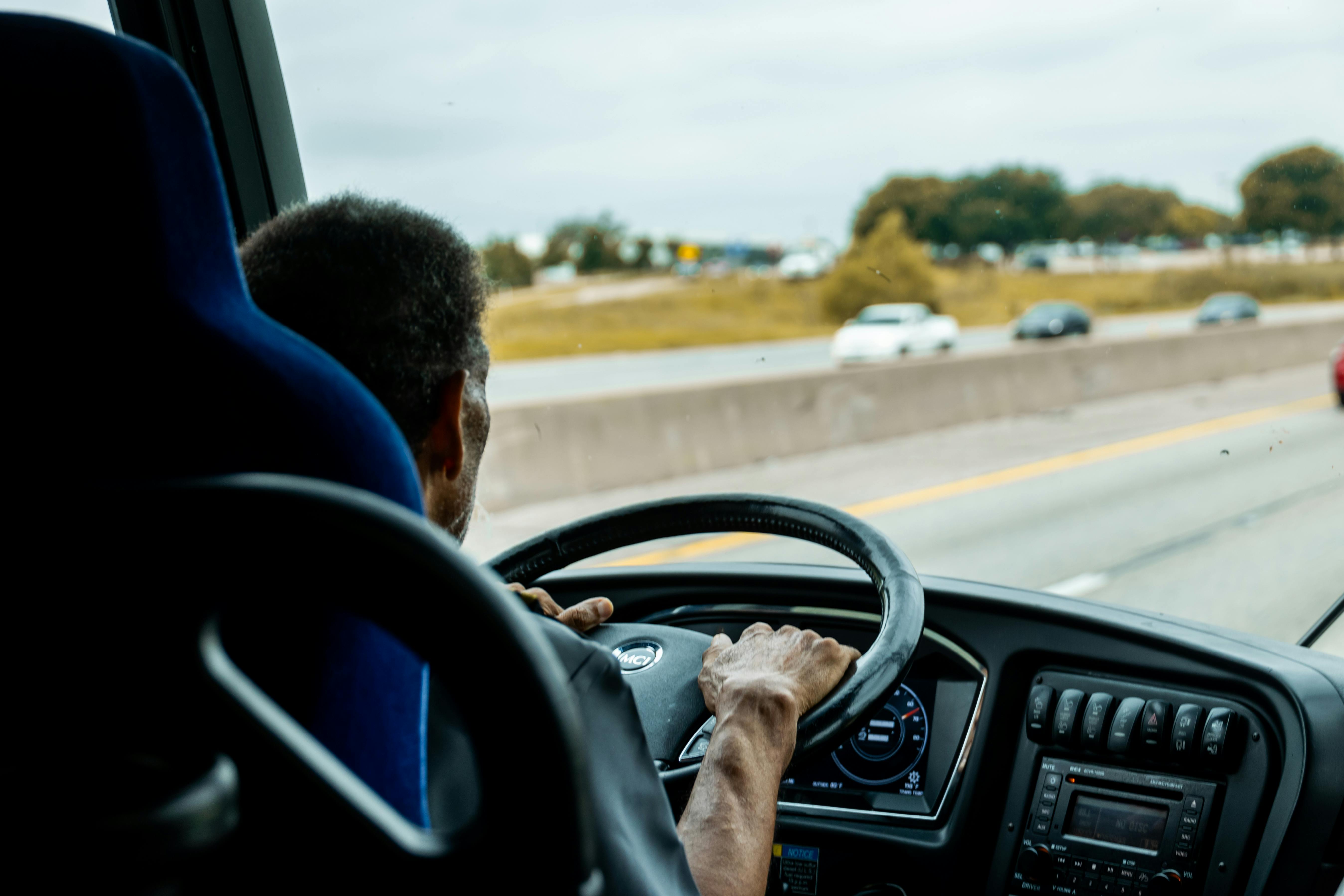 a-bus-driver-skillfully-navigating-a-busy-highway-with-cars-in-the-background. - caleb-oquendo (pexels)