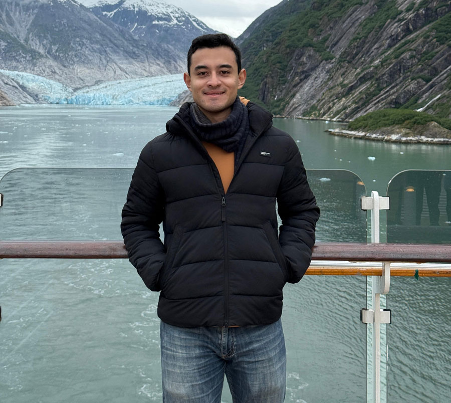Portrait of a laughing person with curly hair wearing a white shirt