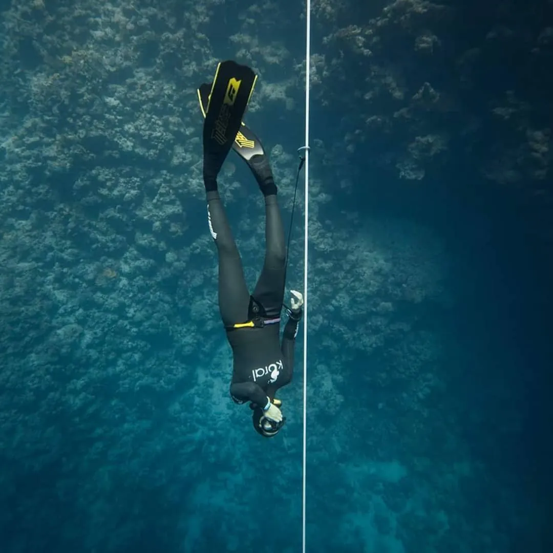 freediver meister taking a selfie with a fish underwater