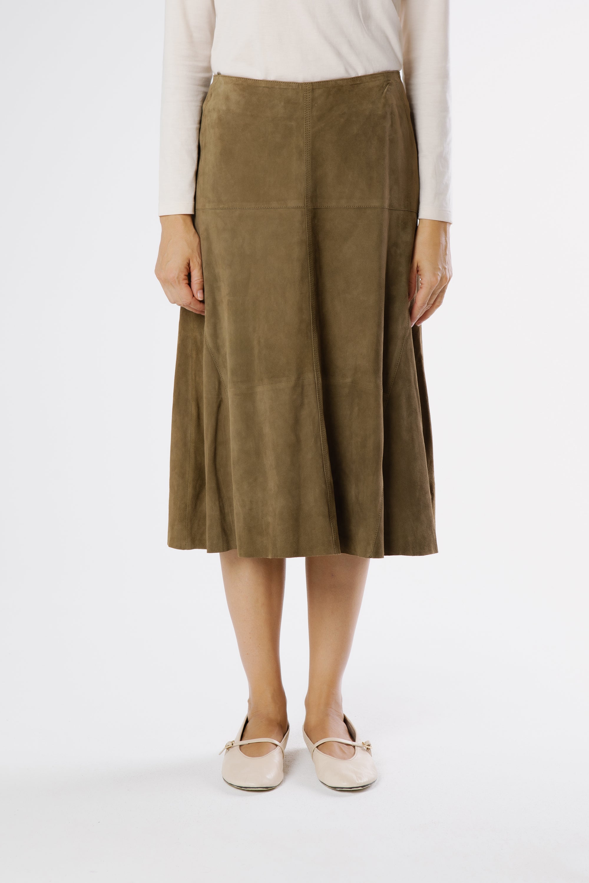 Front view of hazelnut brown suede mini skirt with softly flared shape and panel detailing.
