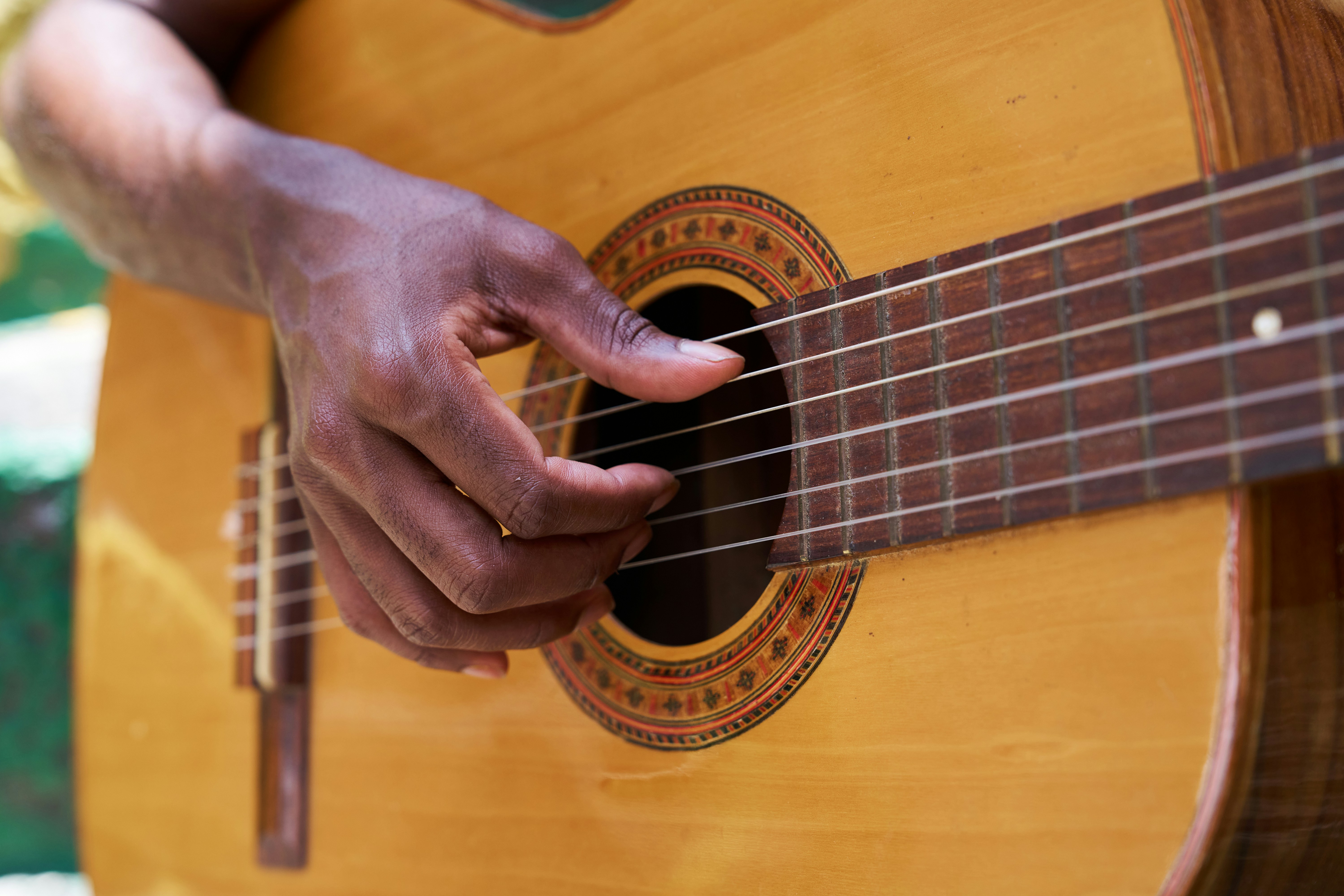 Child struggling with boring guitar scale practice surrounded by sheet music