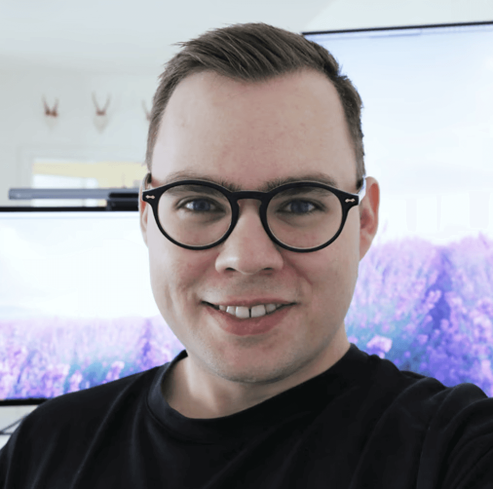 Black and white portrait of a man with a beard and glasses
