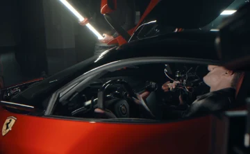 camera being pointed at a Ferrari