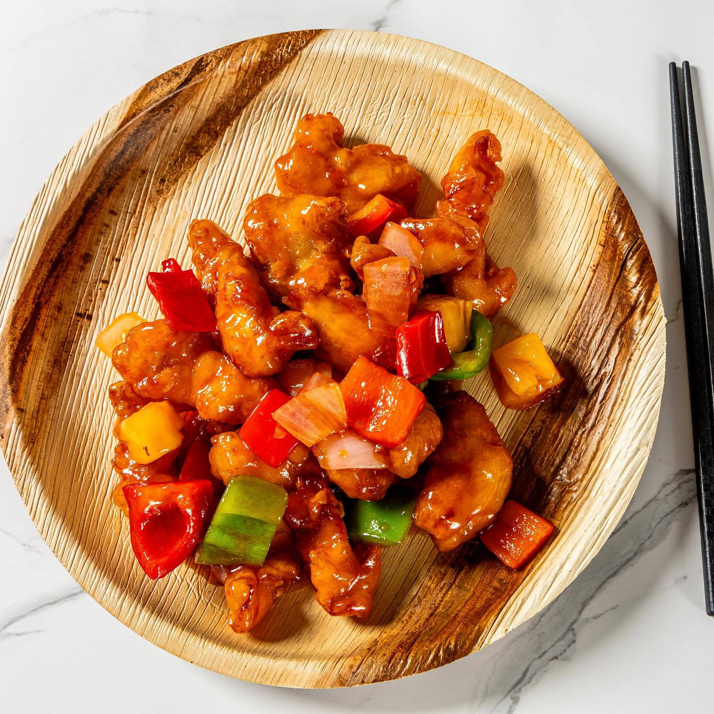 Orange Chicken with Fresh Citrus Twist – Golden, crispy orange chicken drizzled with a vibrant sauce made from fresh orange juice and zest, a signature dish at Everspring Modern Chinese in Tustin, California.