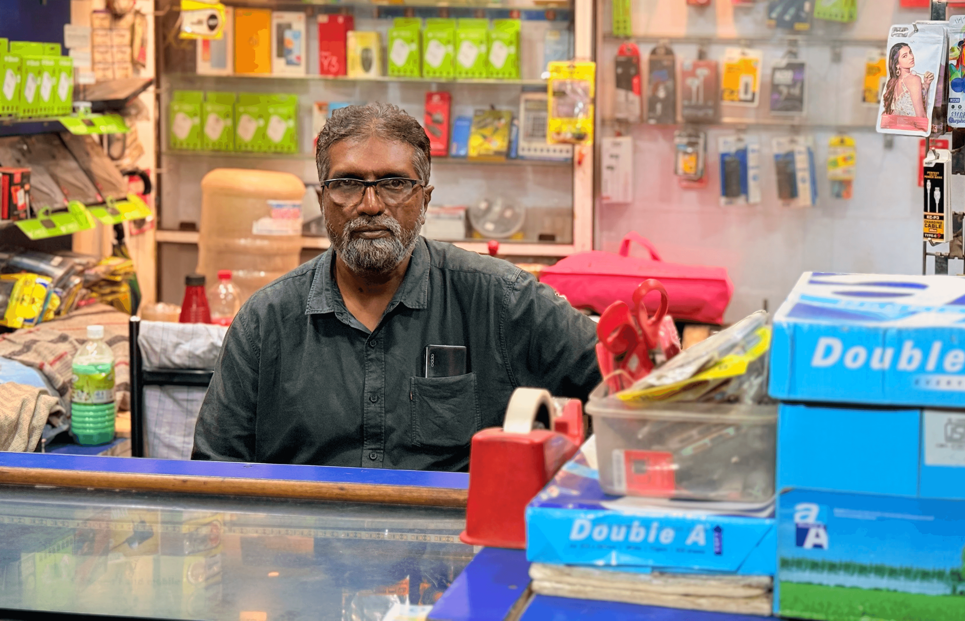 An image of a Shop keeper with his shop