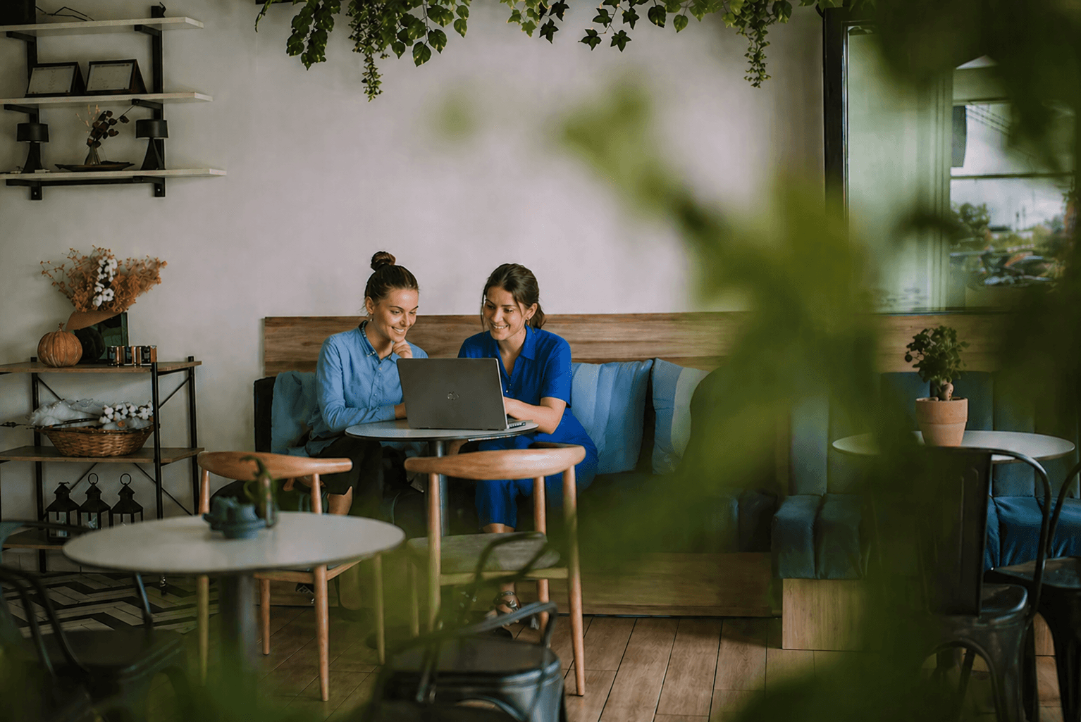 Two shop owners analyze data on their laptop