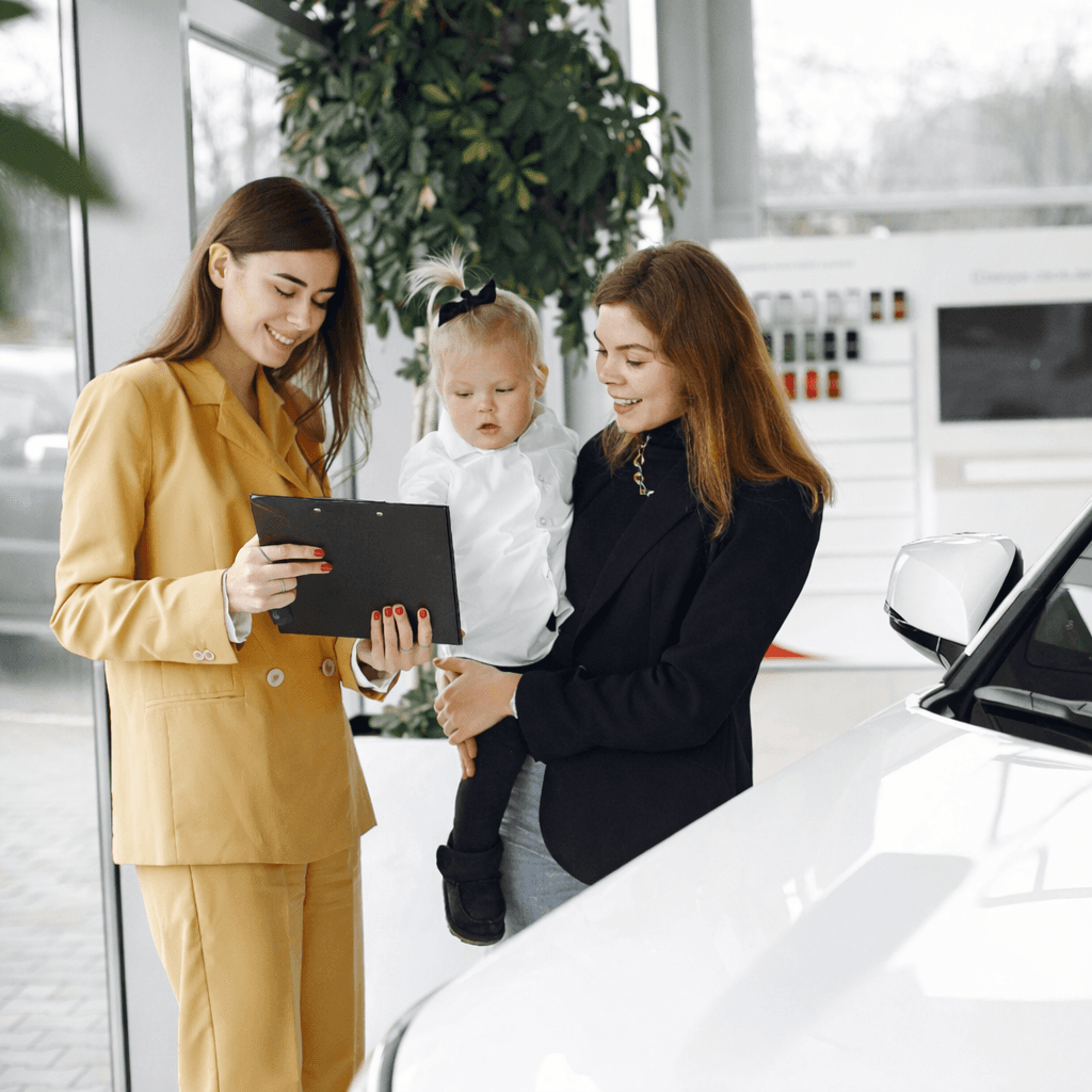 Two women and a child engaged in a small business setting, showcasing customer engagement and communications, emphasizing affordable business phone systems.