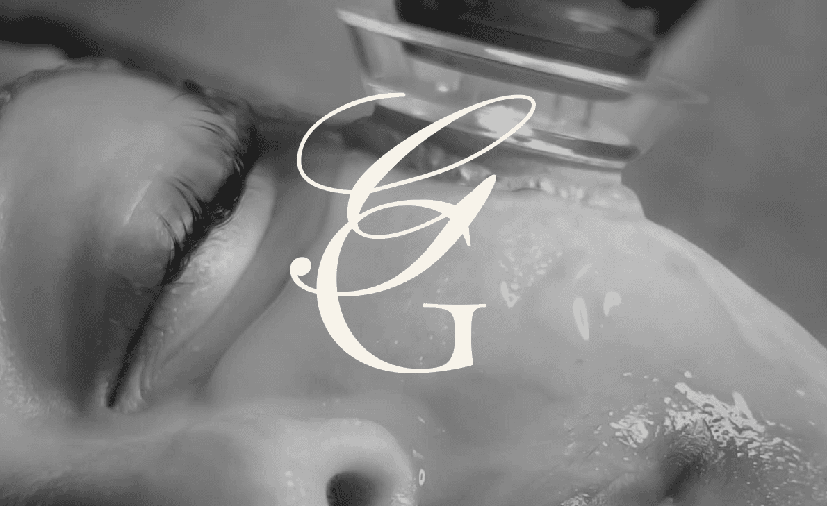 A woman getting a Glo2Facial treatment with the Glow Garden Studio submark overlayed