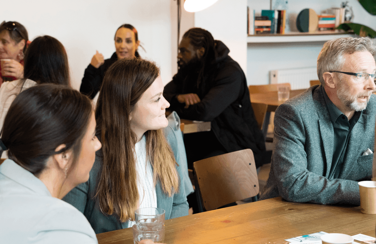 People sitting around a table having conversation.