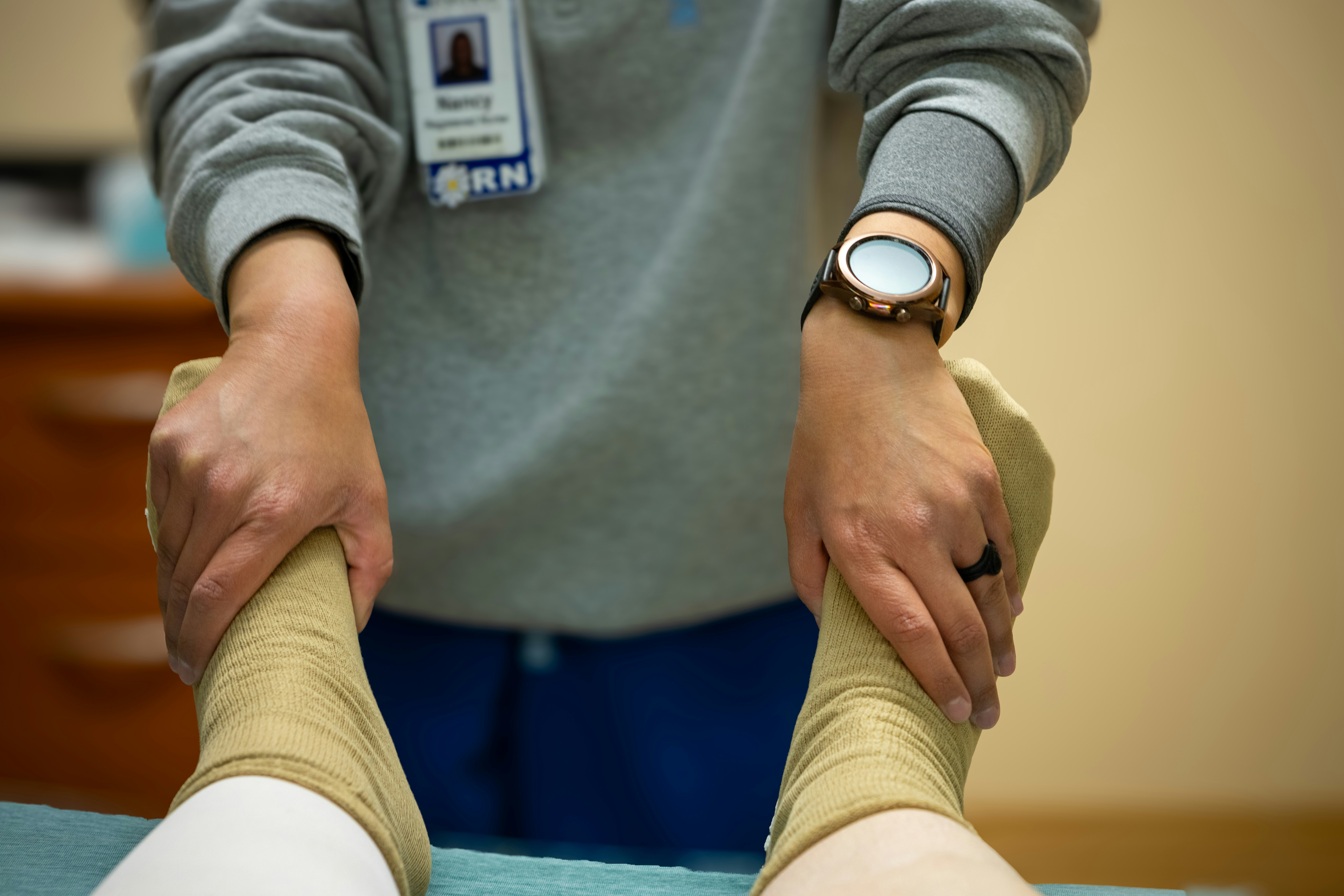 doctor helping a patient stretching their legs