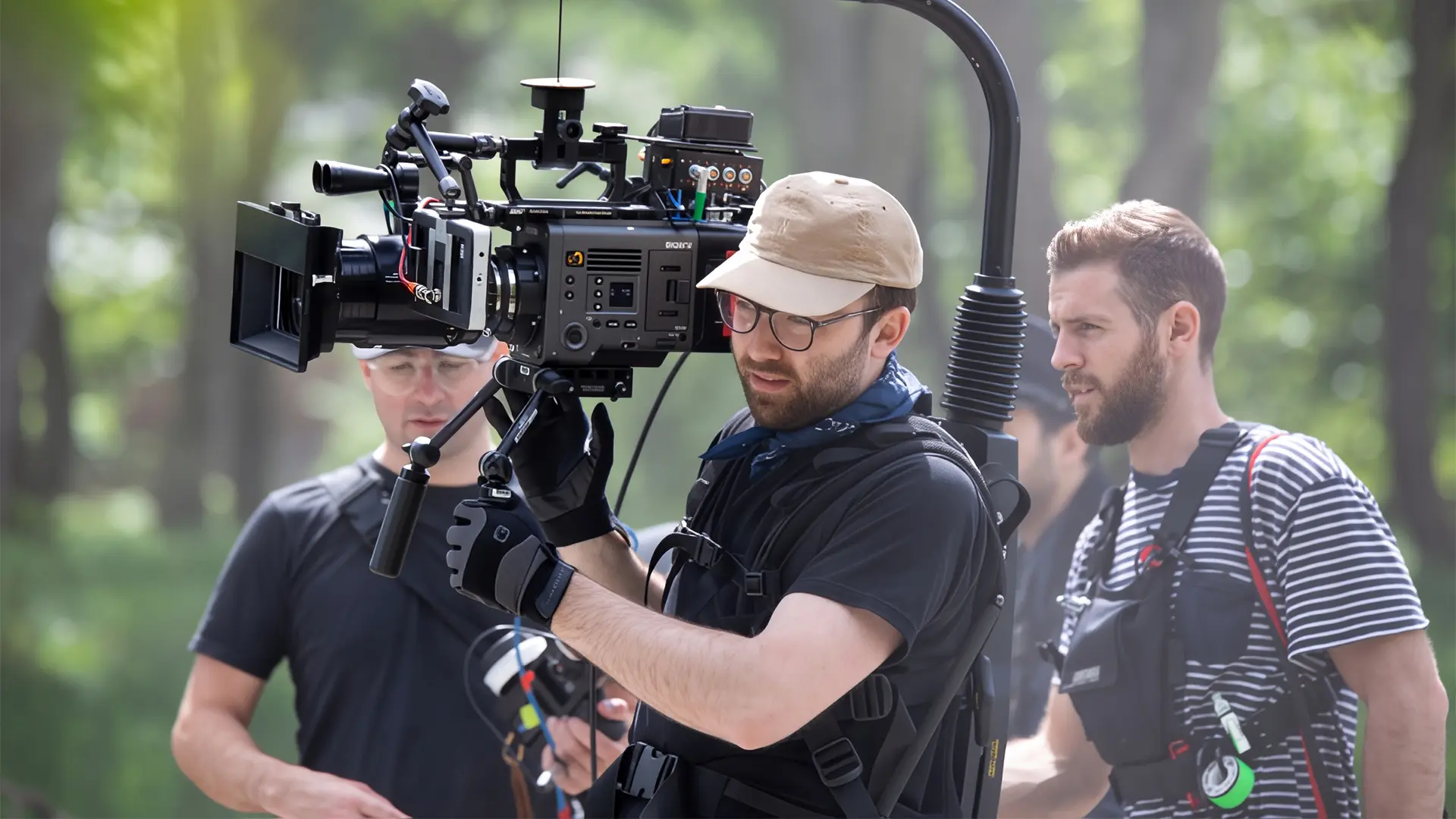 Camera operator filming on location using a shoulder-mounted cinema camera rig