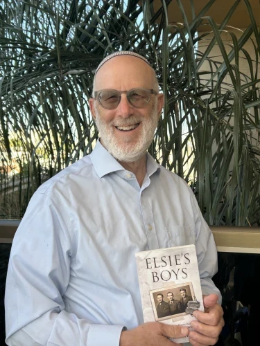 Author Moshe R. Manheim holds a copy of his new book, <strong>Elsie’s Boys,</strong> May 28, 2026. Photo courtesy Courtesy.