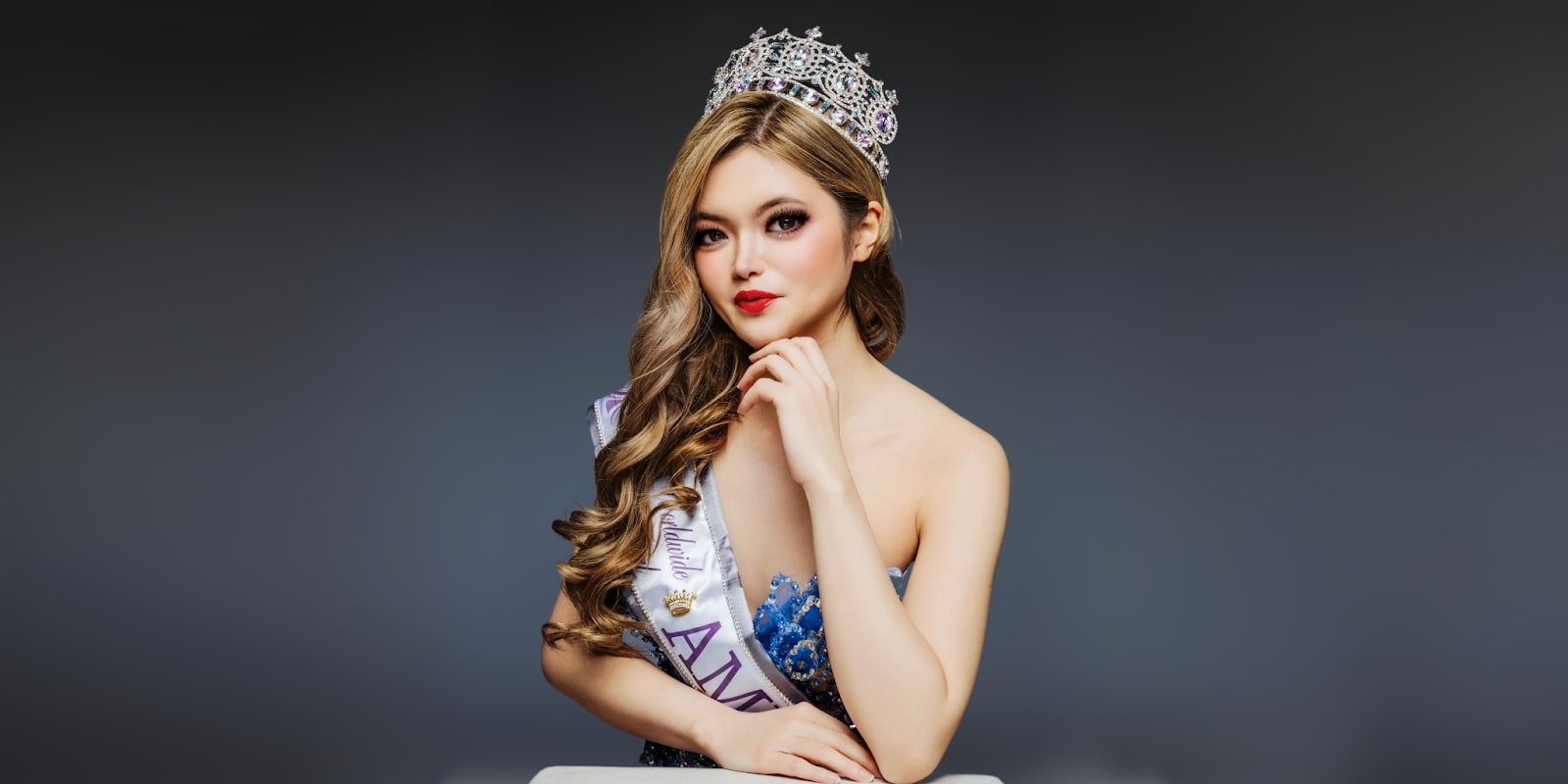 Sarah Ong, award-winning beauty queen and social advocate, poses in her crown and sash, representing Australia’s pageant history.
