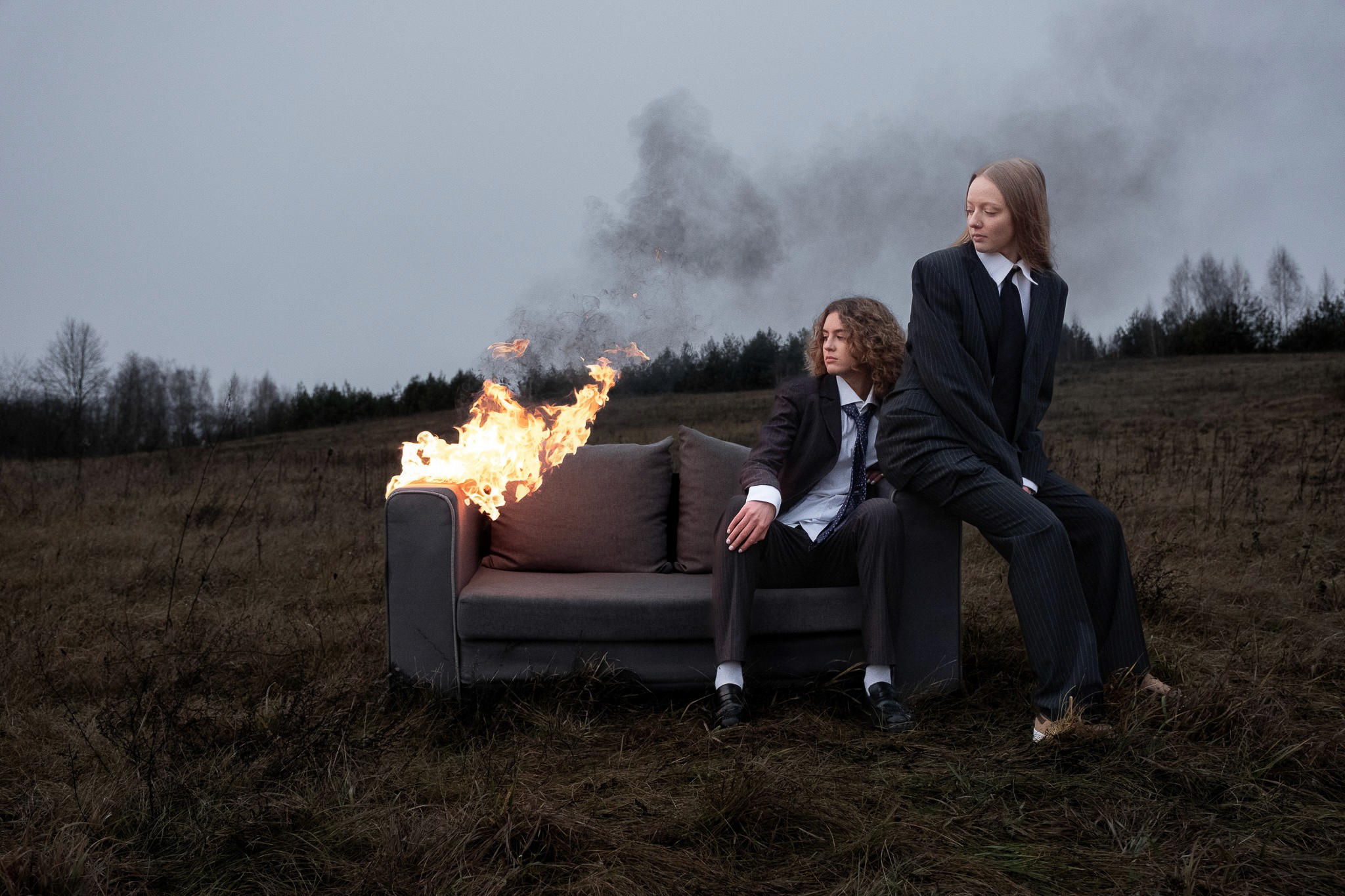 woman sitting on a burning couch