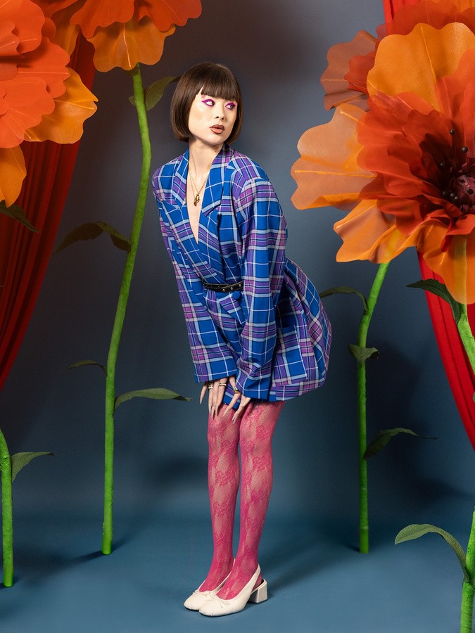 white woman psoing for a picture in a colorful background