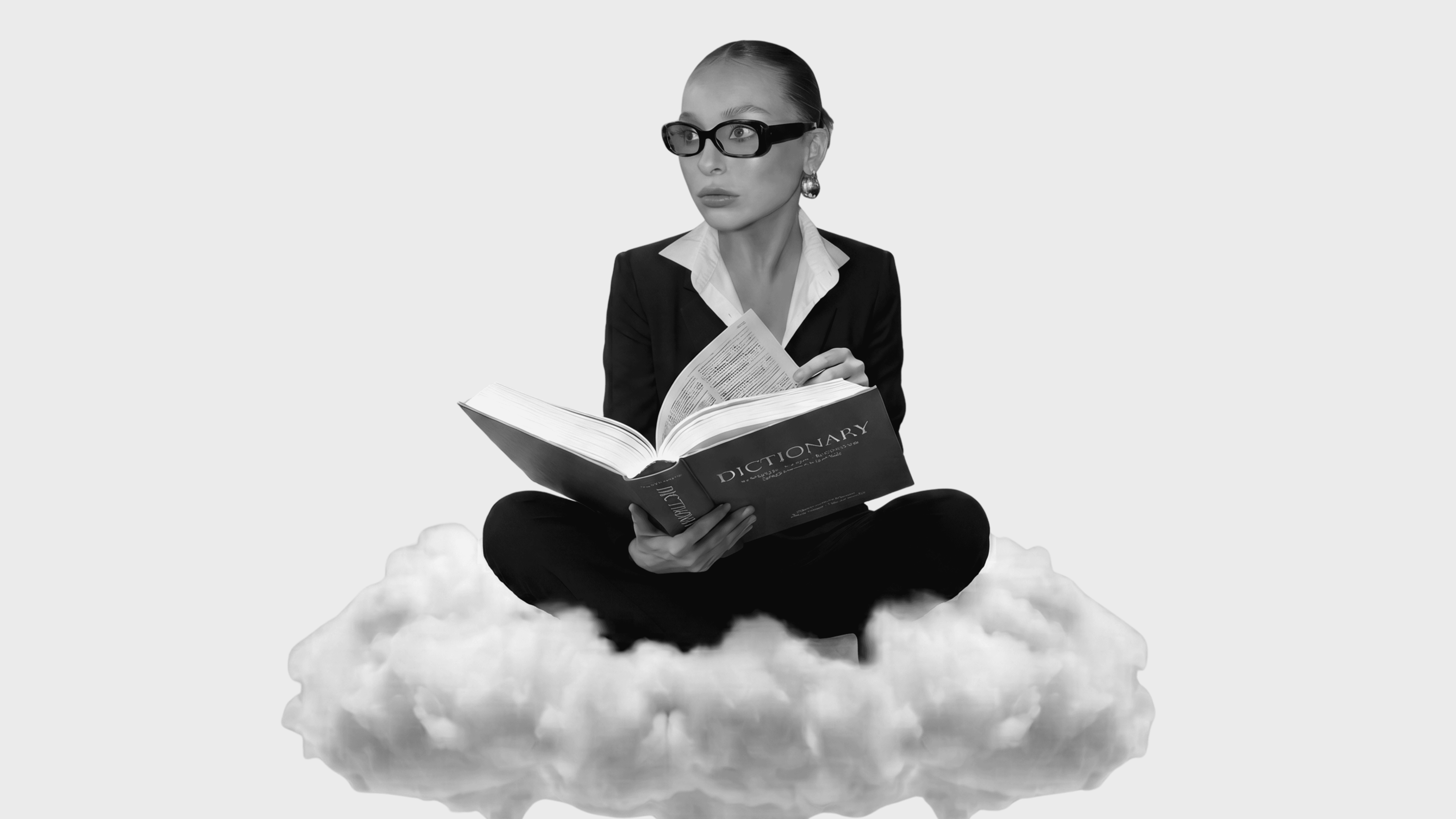 Editorial photograph of a woman in glasses reading a dictionary on a cloud, illustrating Five Six Studio's legal page.