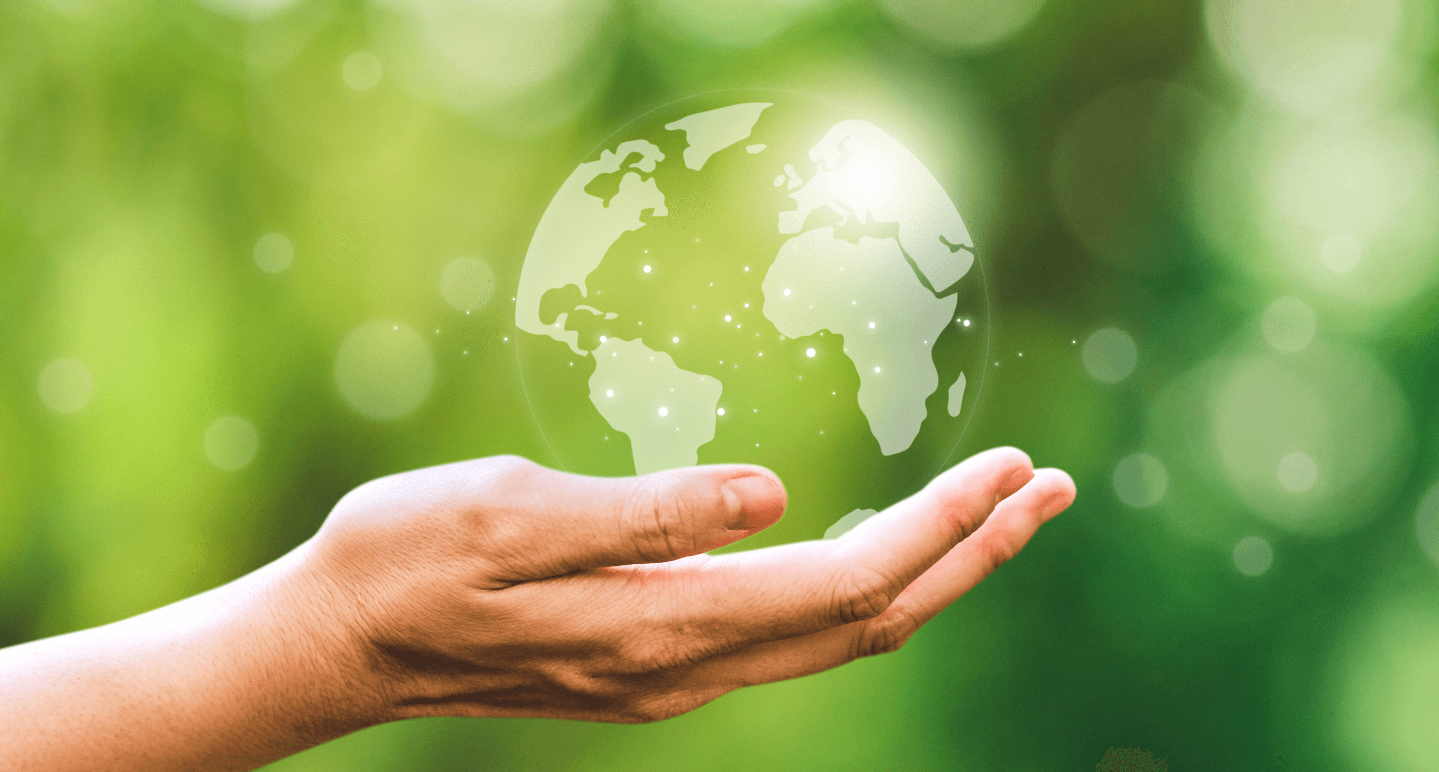 Modern glass building with illuminated facade and cityscape view at sunset