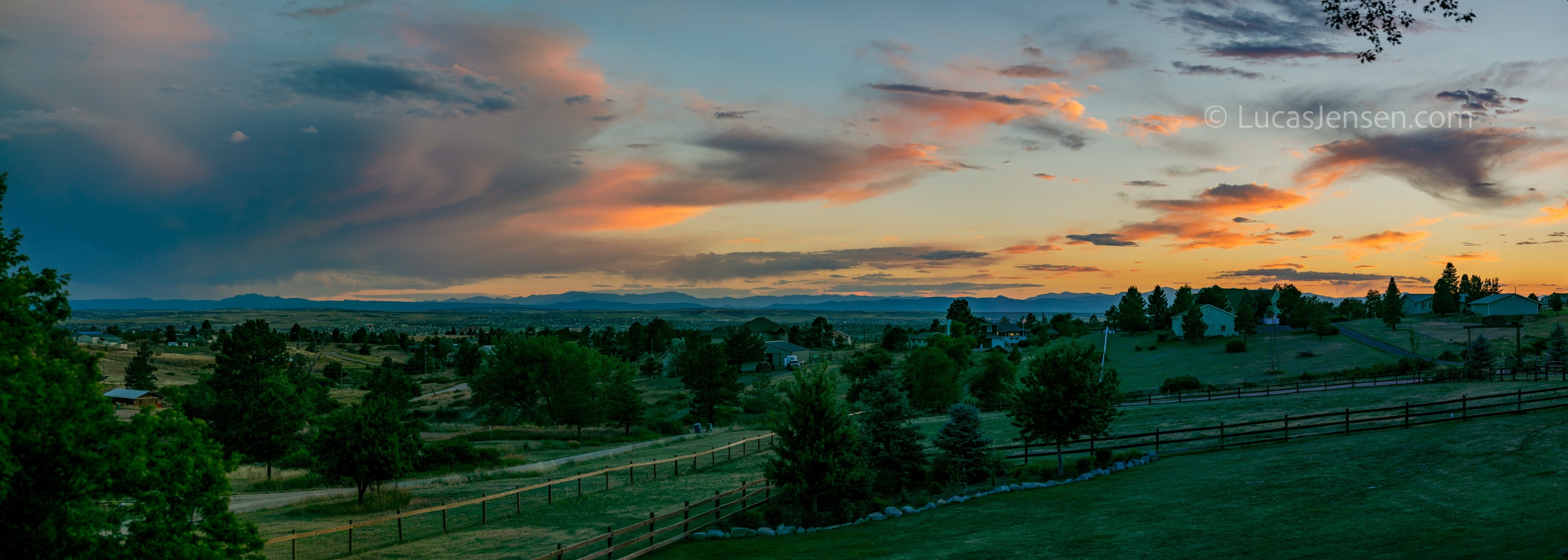 Panoramic landscape photograph of mountains, water, desert, or coast by Lucas Jensen