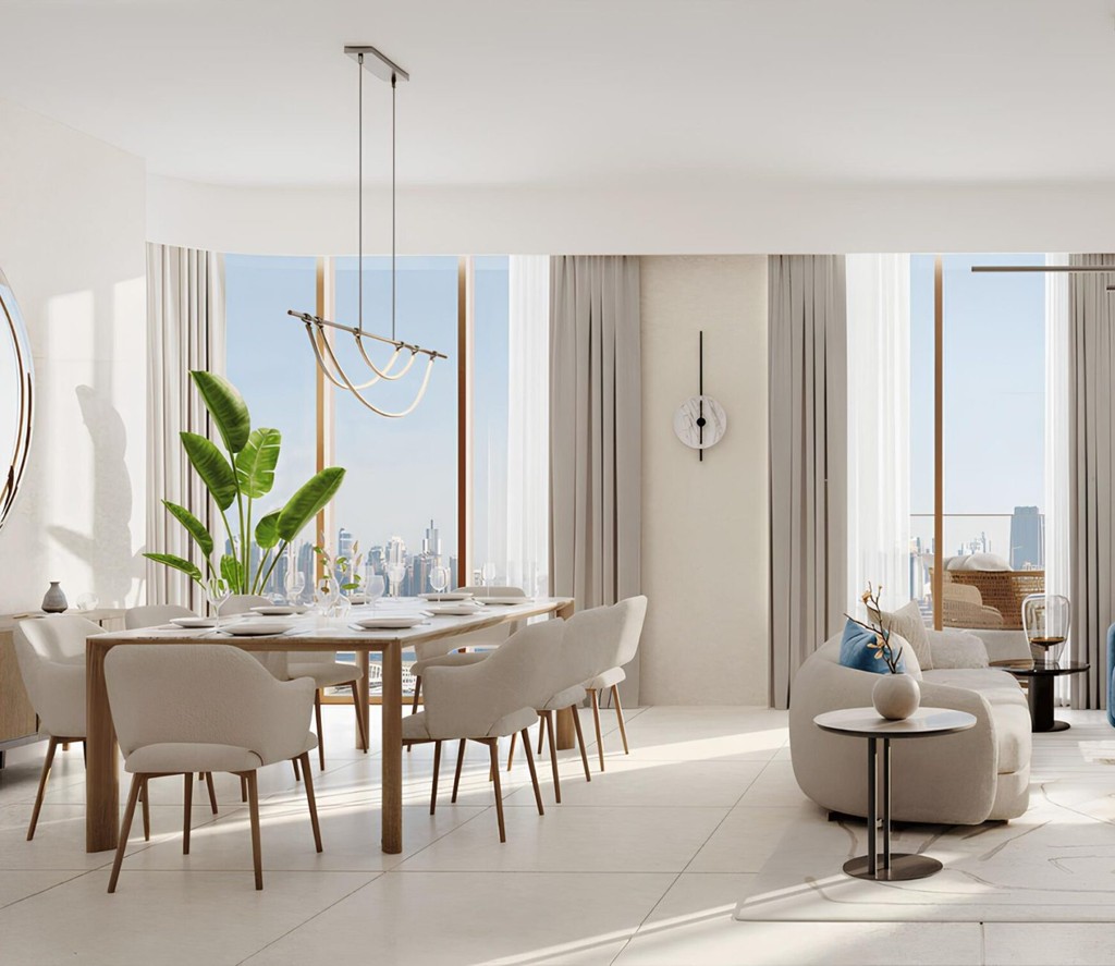 A modern living room at Flora Shore Beachfront Residences, featuring a panoramic view of the city skyline.