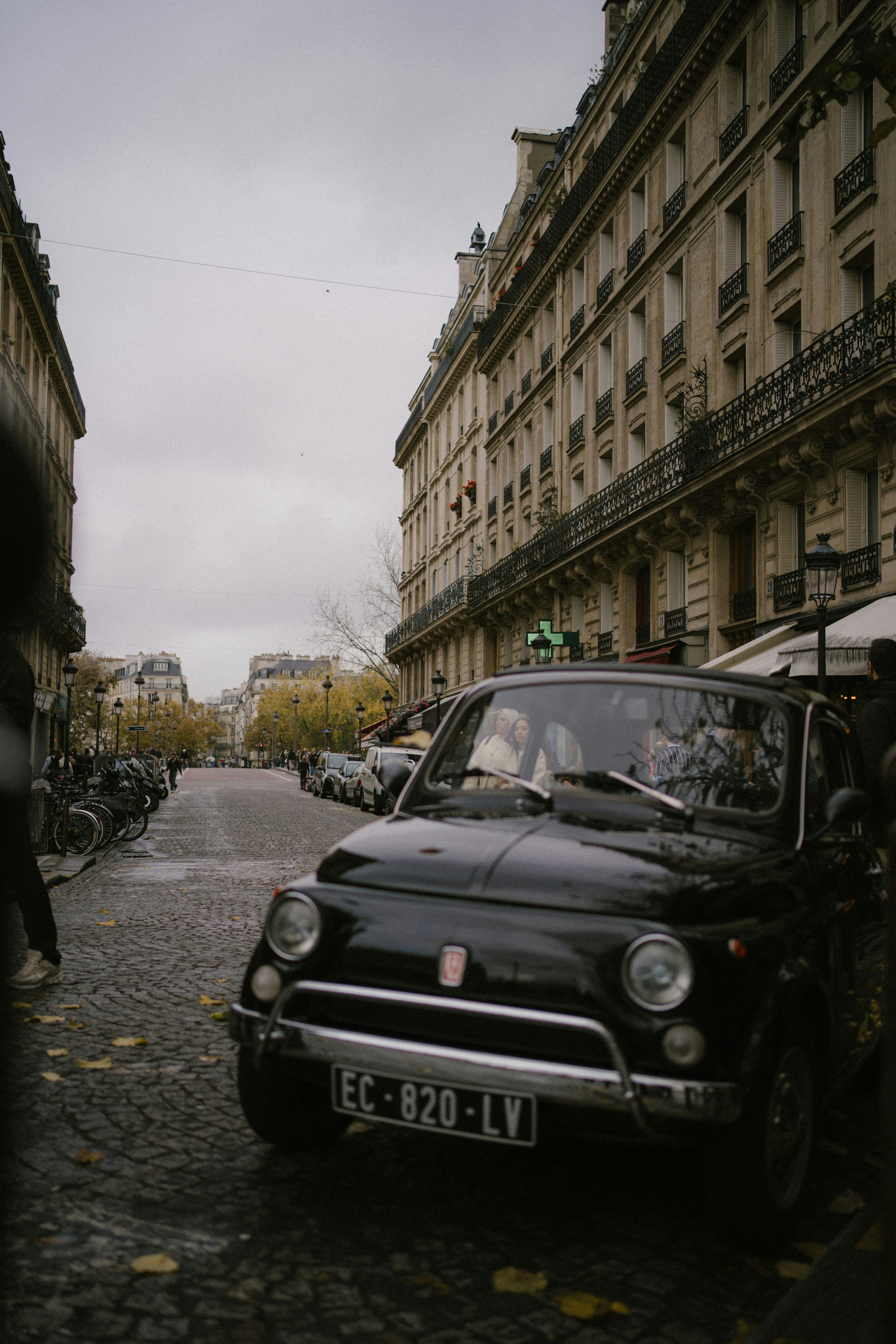 Black vintage car parked on parisian street