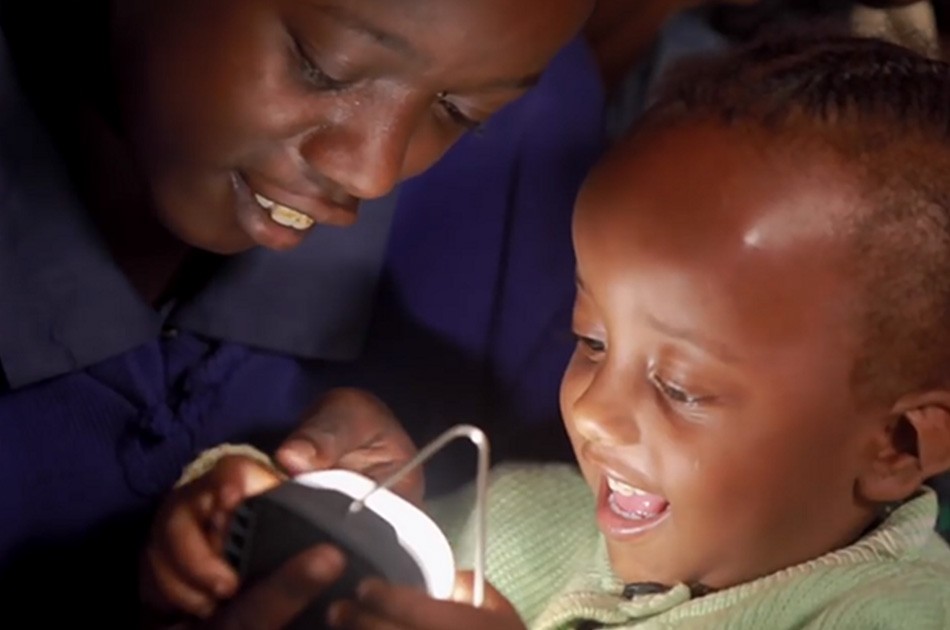 Happy child holding a portable light.