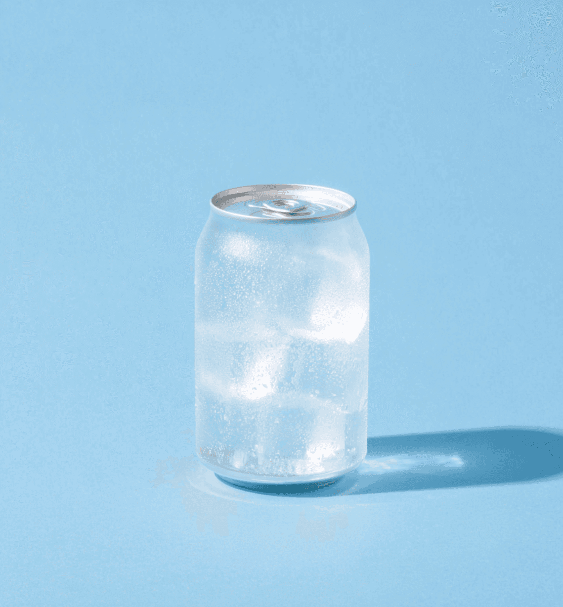 frosted aluminum can with condensation on light blue background