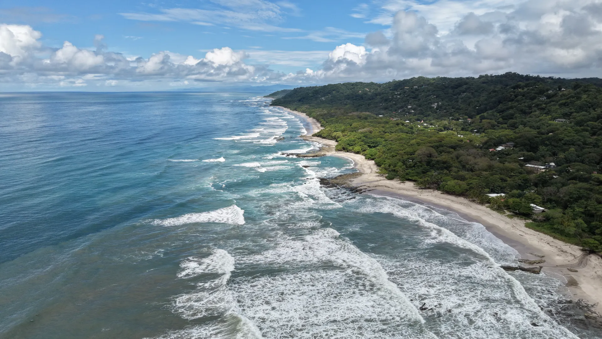 Aerial view of Playa Carmen and Santa Teresa, Costa Rica, with jungle-covered hills and white sand beaches