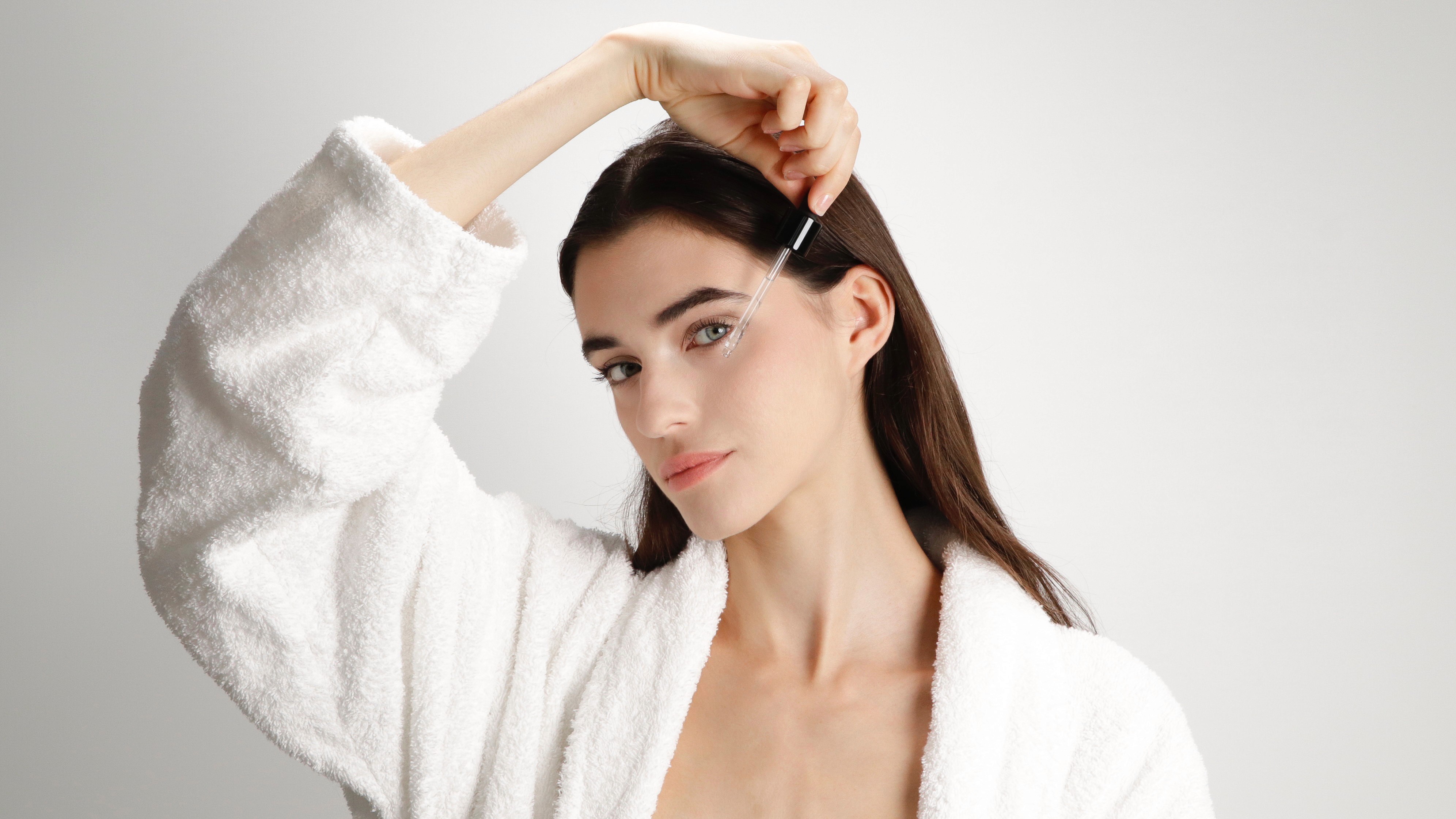 Stack of modern books and magazine with minimalist cover design on leather chair
