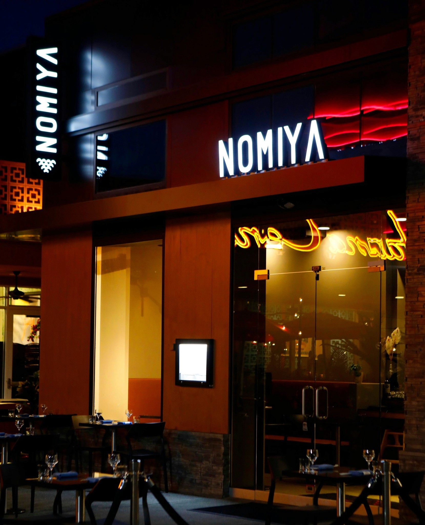 The sleek, illuminated Nomiya sign welcomes guests to this modern Japanese dining destination, known for its premium sushi and expertly crafted dishes in Roosevelt Field Mall.