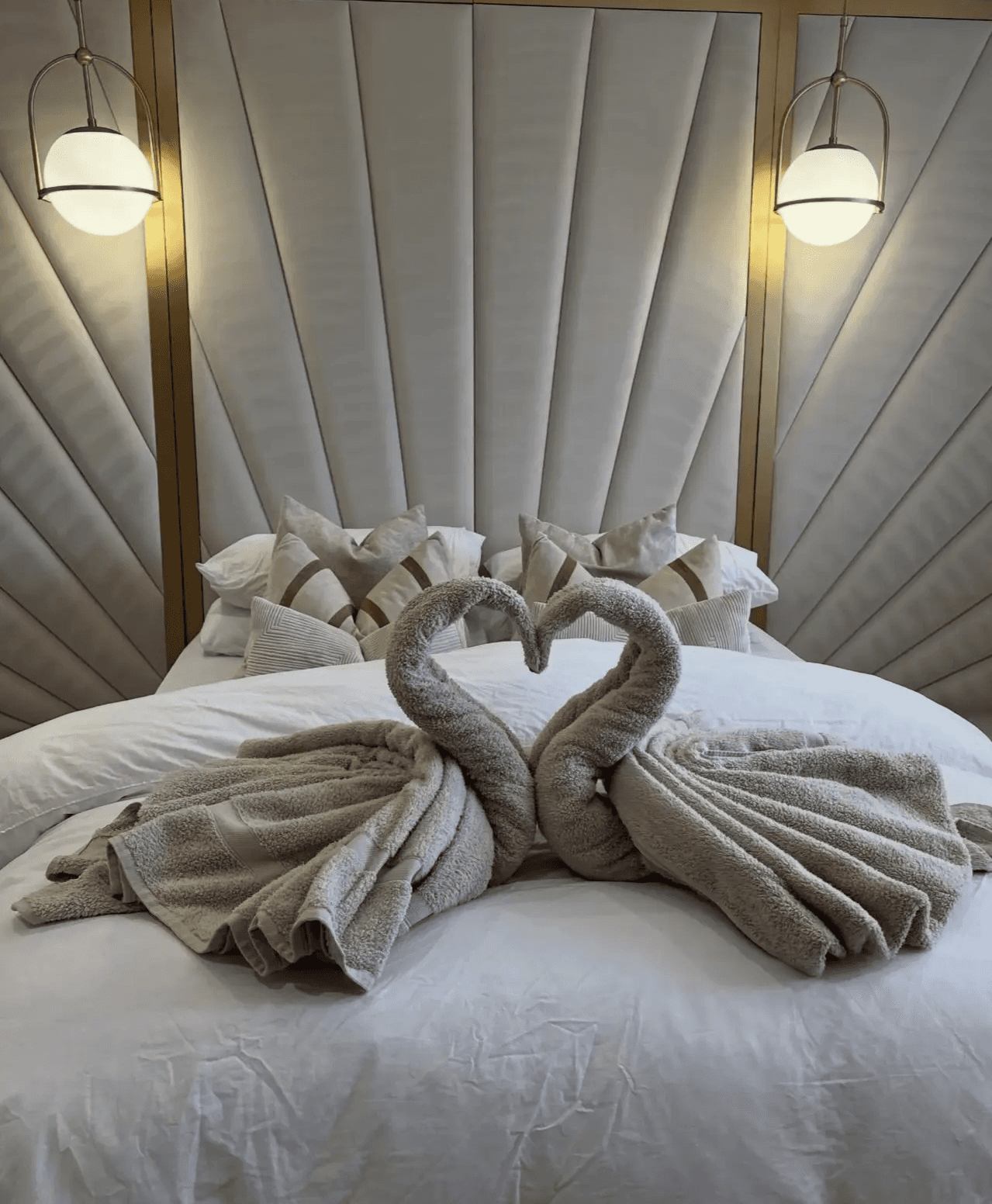 Detailed view of custom towel folding on clean white linens, highlighting the luxury standards of a Gilbert professional cleaning company.