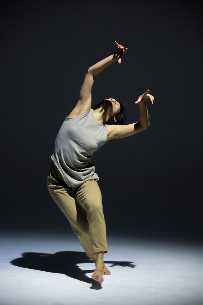 a man is doing a dance move in the dark