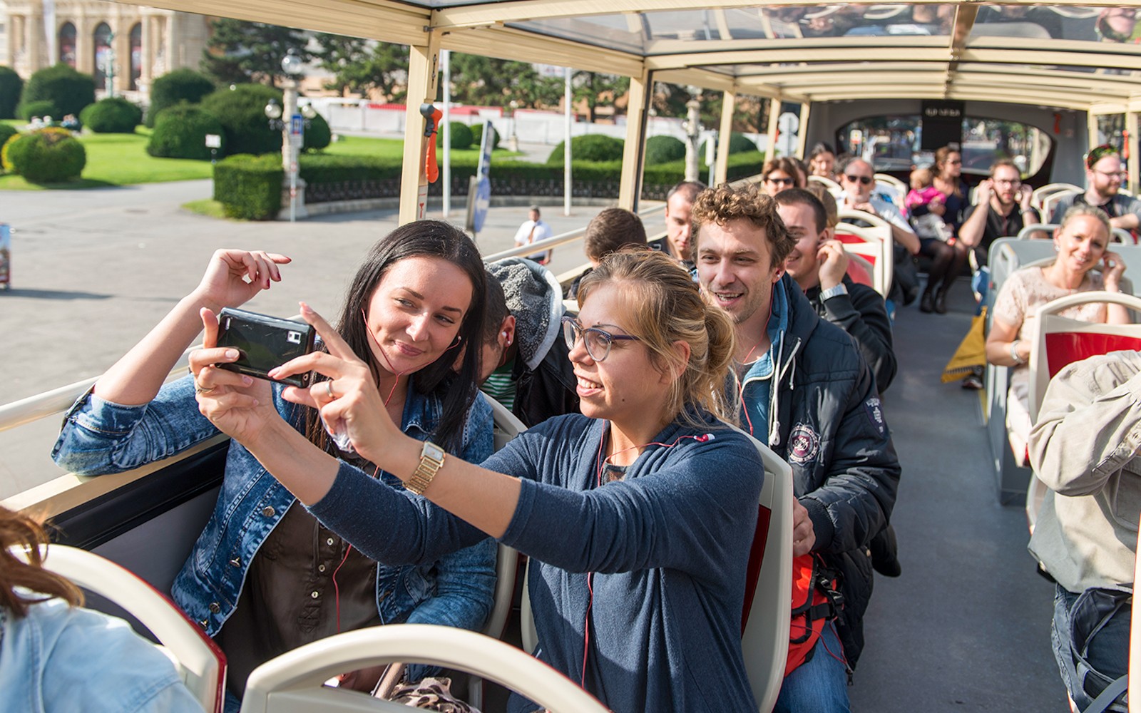 Passengers taking photos on a Vienna Hop-On Hop-Off bus tour.