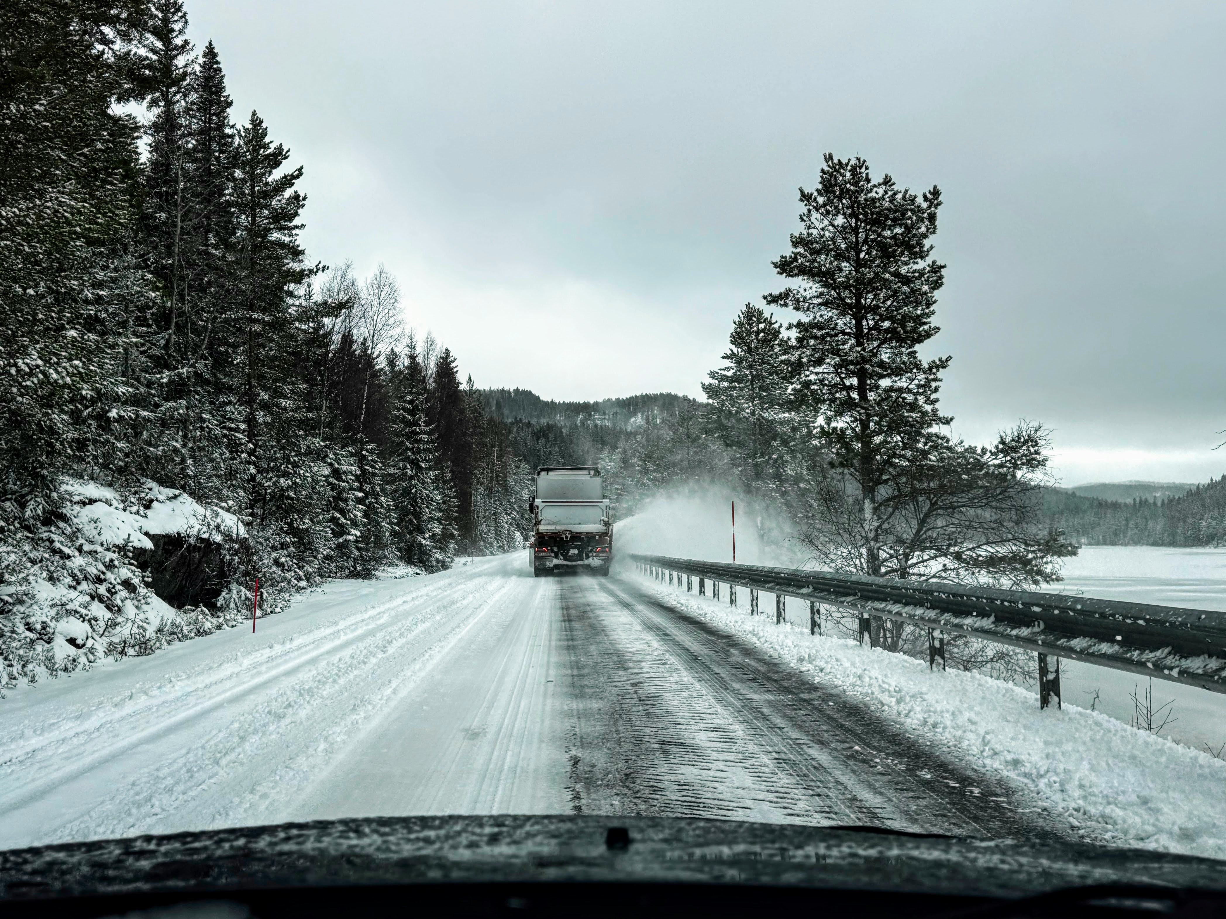 Truck driving on a snowy road in winter