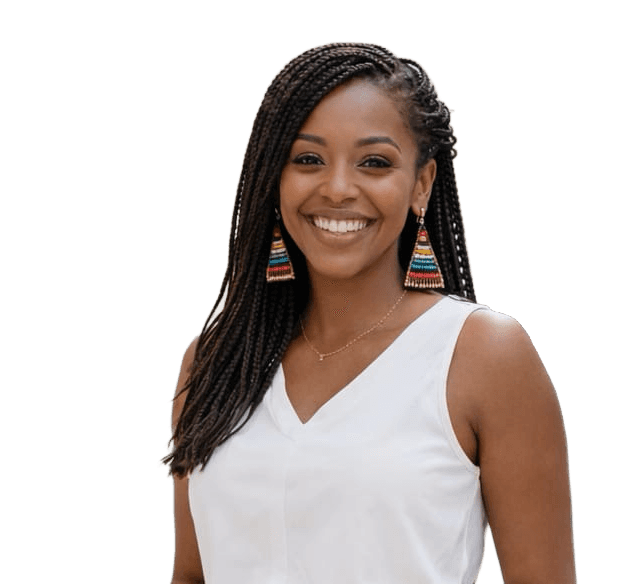 Smiling woman sitting at desk with a computer, surrounded by plants.