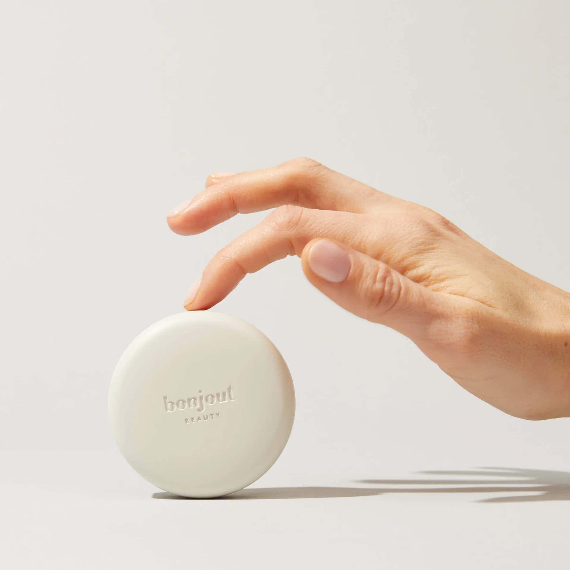 Hand applying skincare product