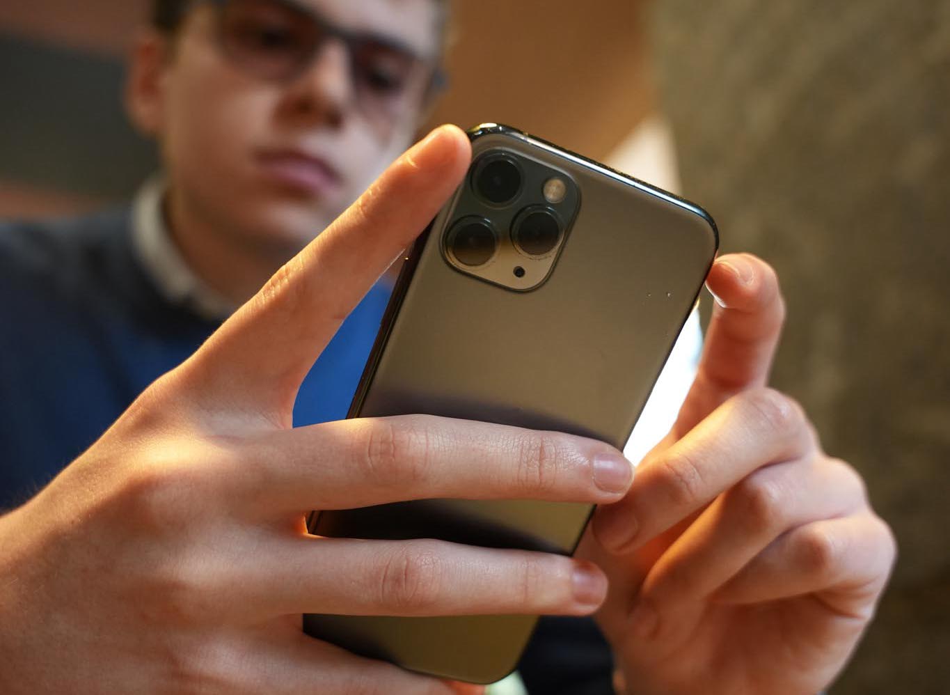 man filming on beach