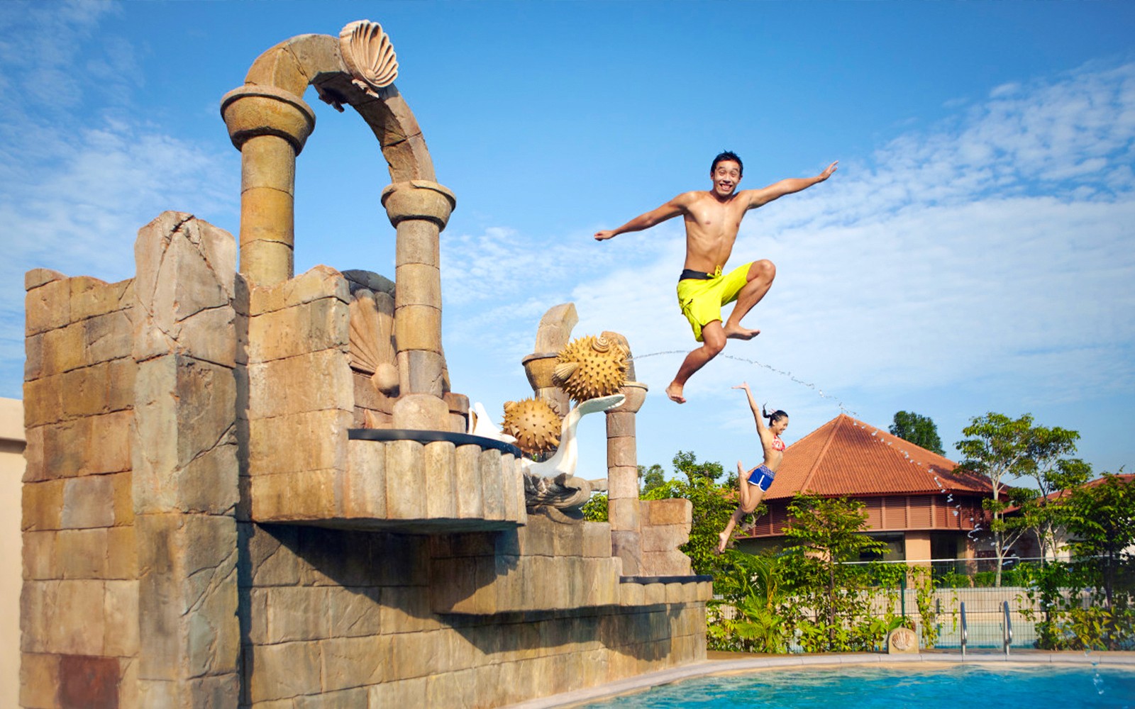 Visitors jumping into a pool at Adventure Cove Waterpark™‎, Singapore.